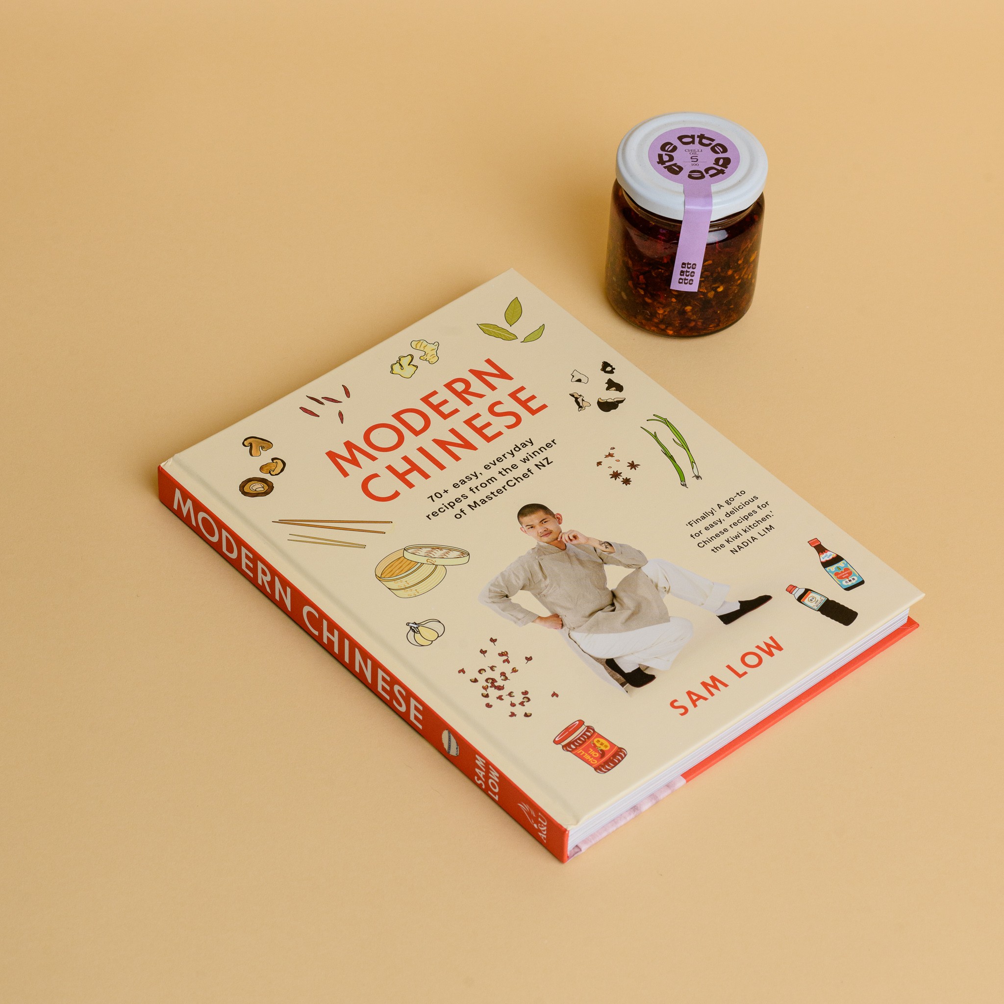 A cookbook with Sam Low on the front and a jar of chilli oil