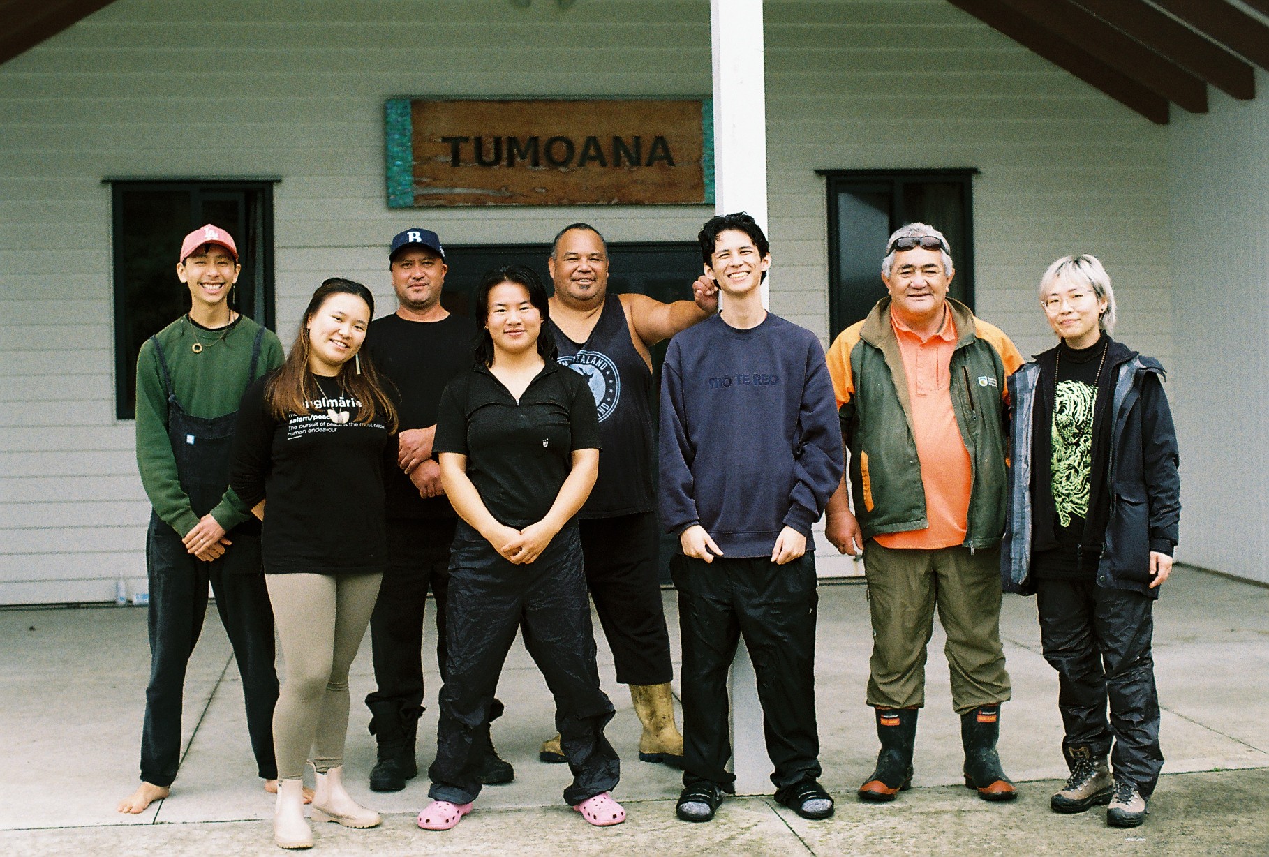 A group of people standing in front of a marae