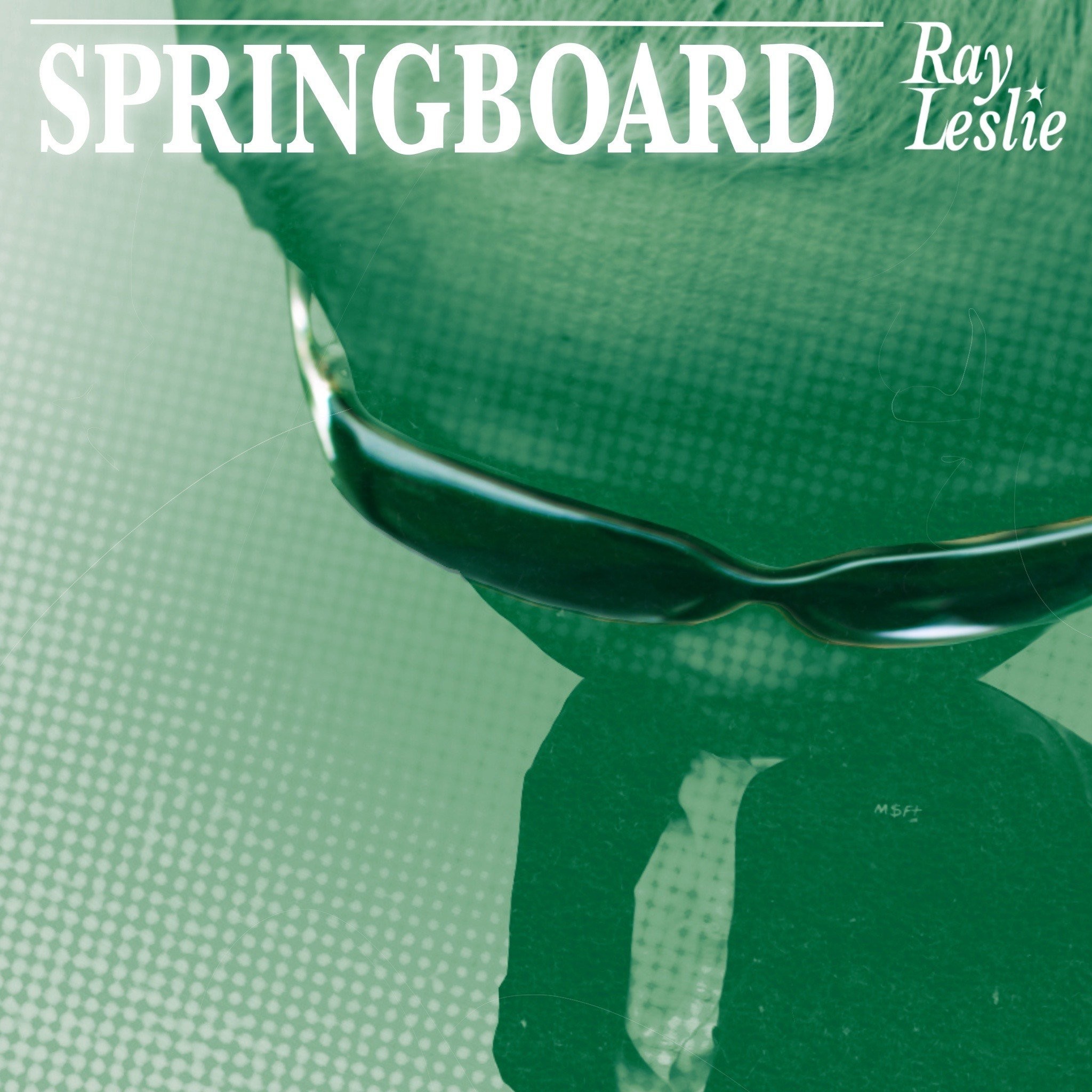 Stylised photo of a person wearing black oversized sunnies taken from a birds eyeview with the text 'Springboard, Ray Leslie' at the top