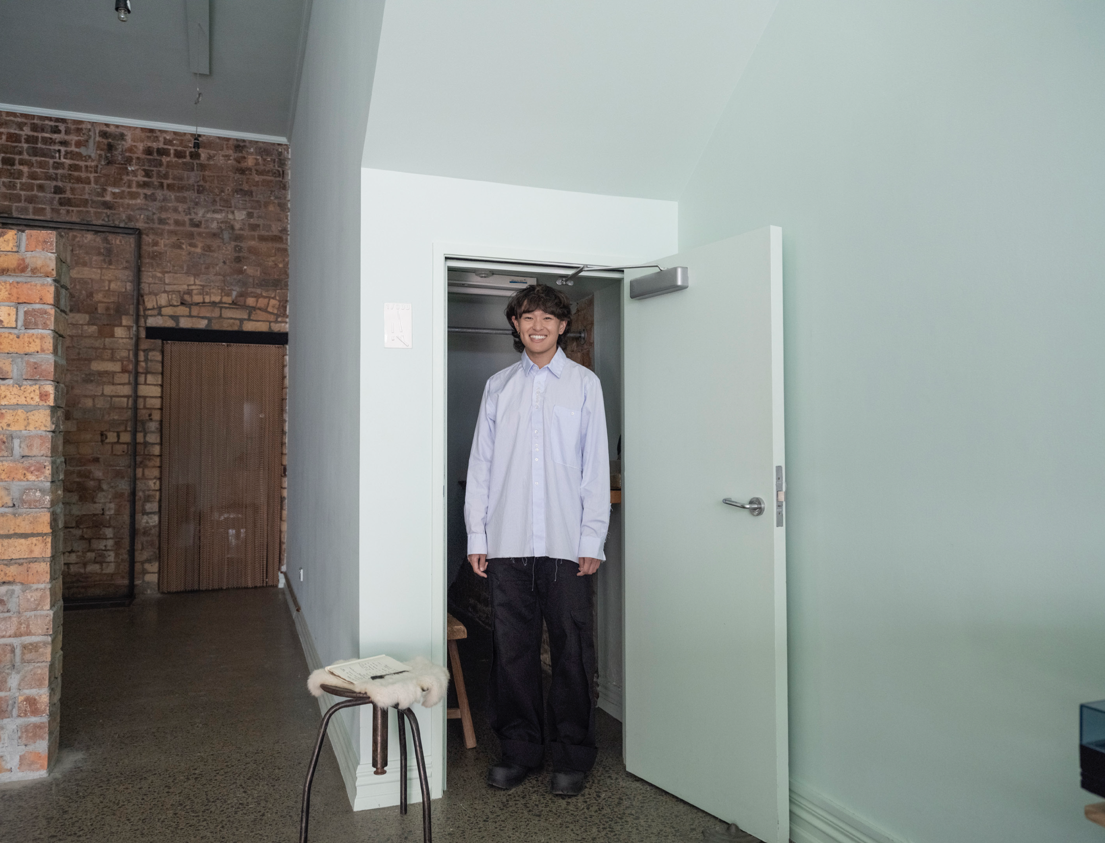 a man standing at a door at his studio