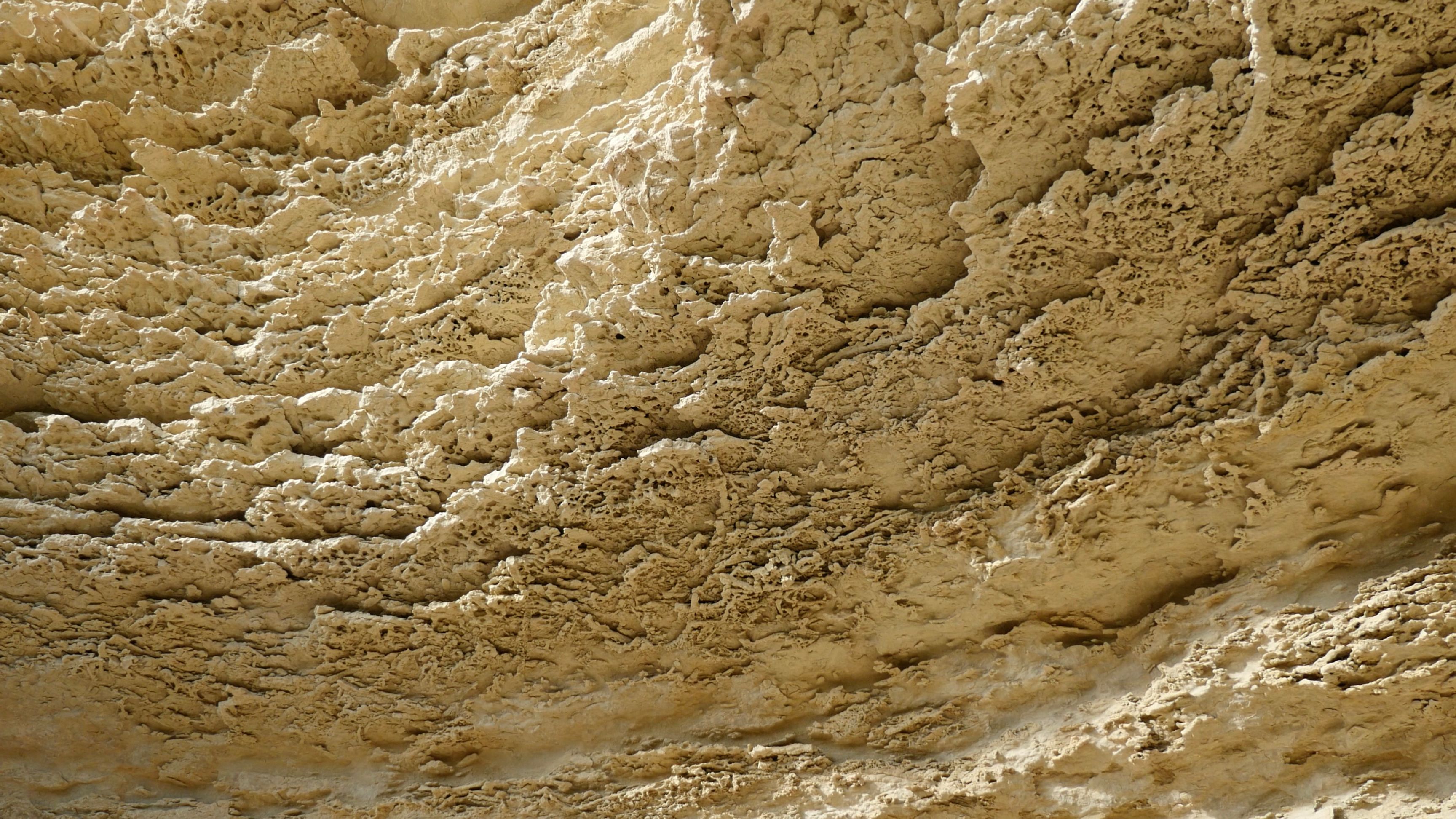 Creamy yellow limestone formations, photographed from below.