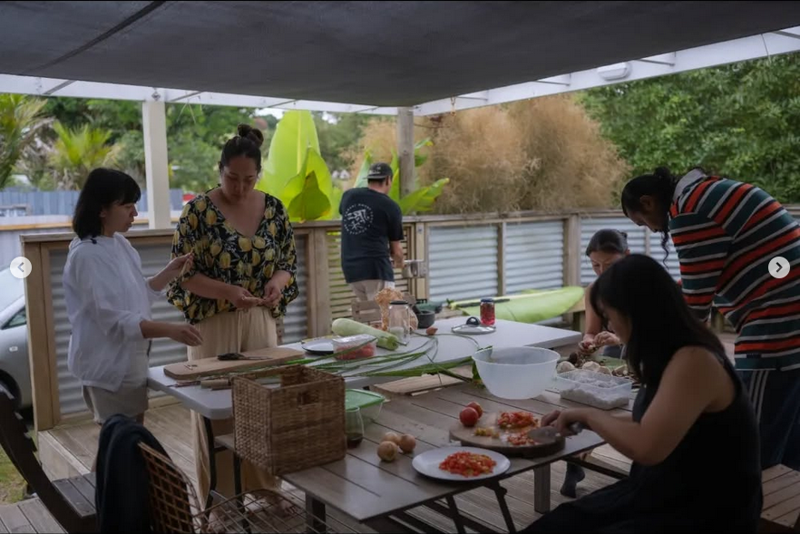 People cooking together outdoors.