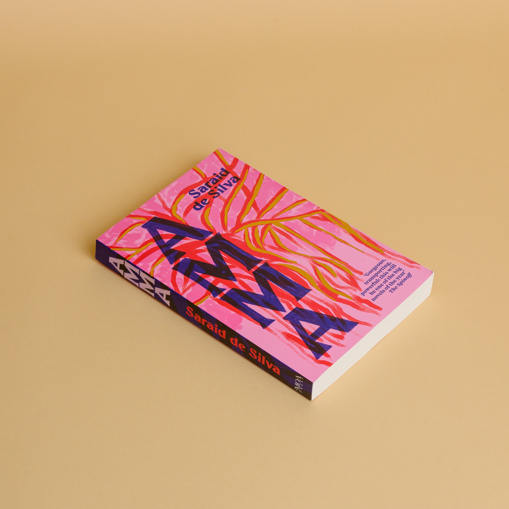 A pink book with leaves in red across the background and the text 'AMMA' down the side