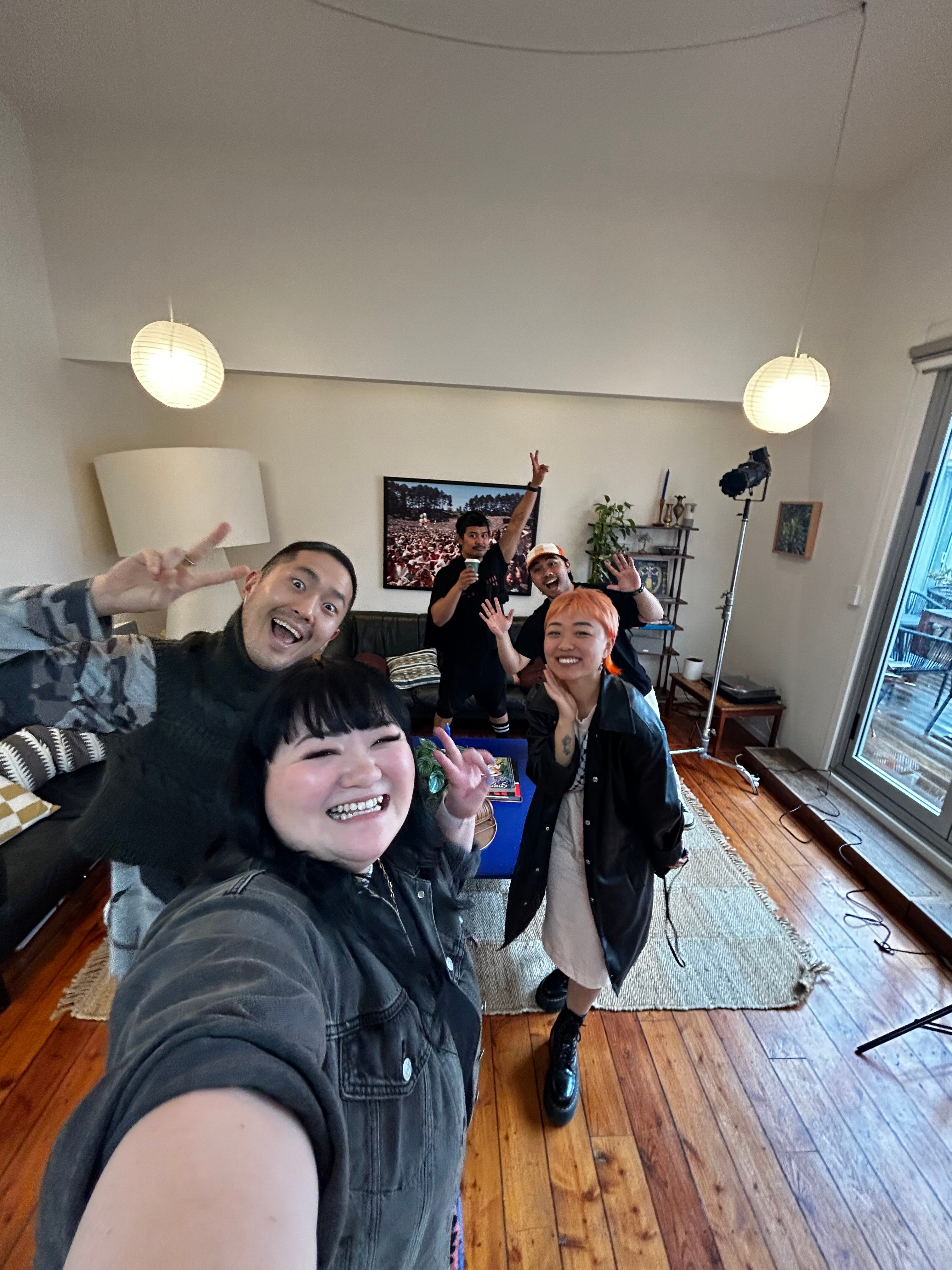 A selfie with five people all smiling at the camera