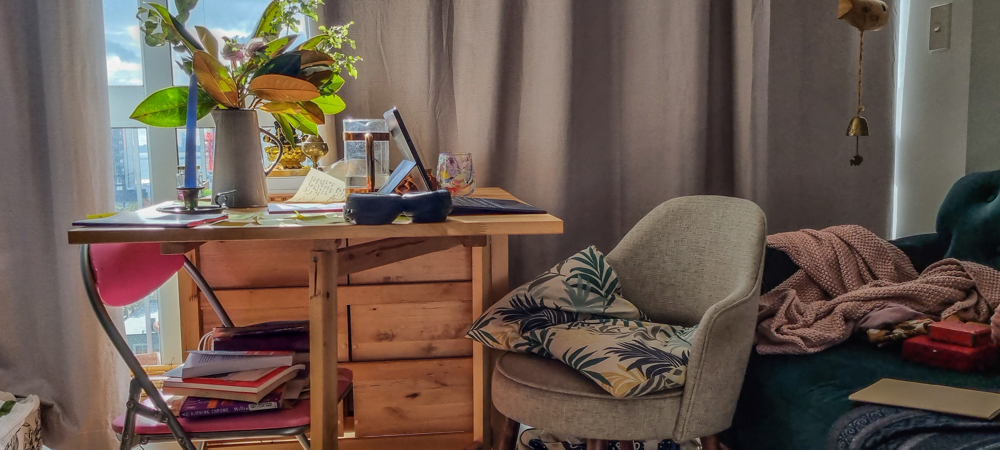 A cluttered desk in an apartment.