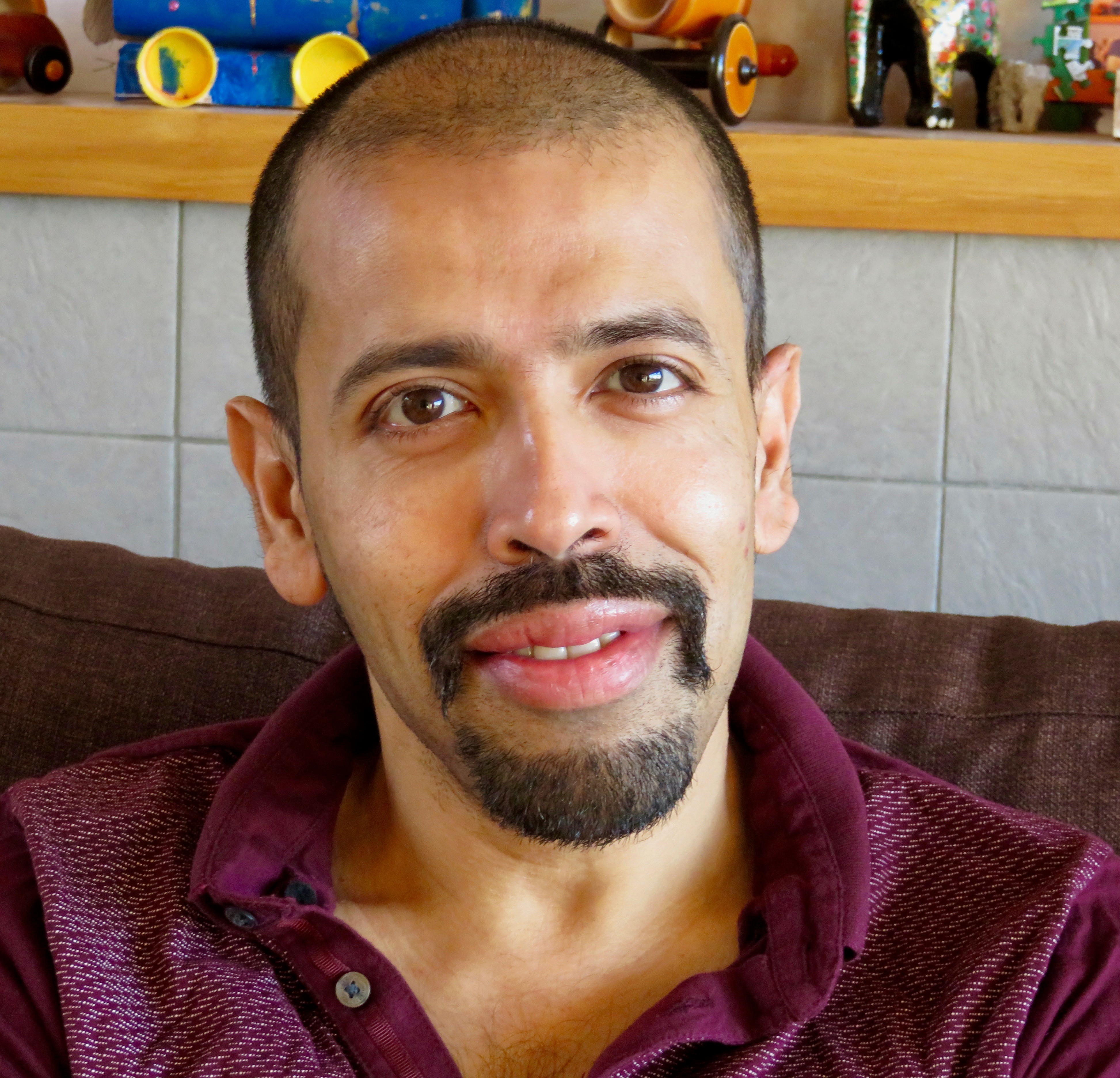 A man sitting on a couch smiling