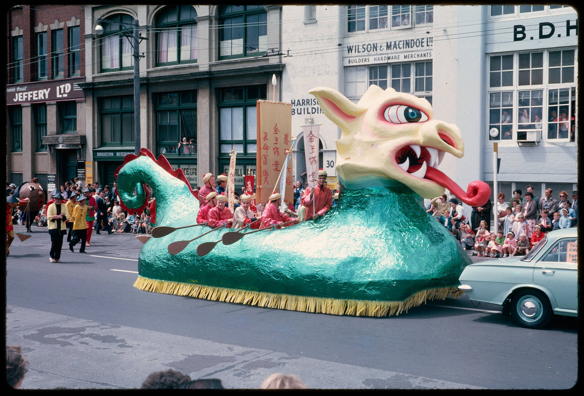 Photo of a dragon shaped float in a parade.