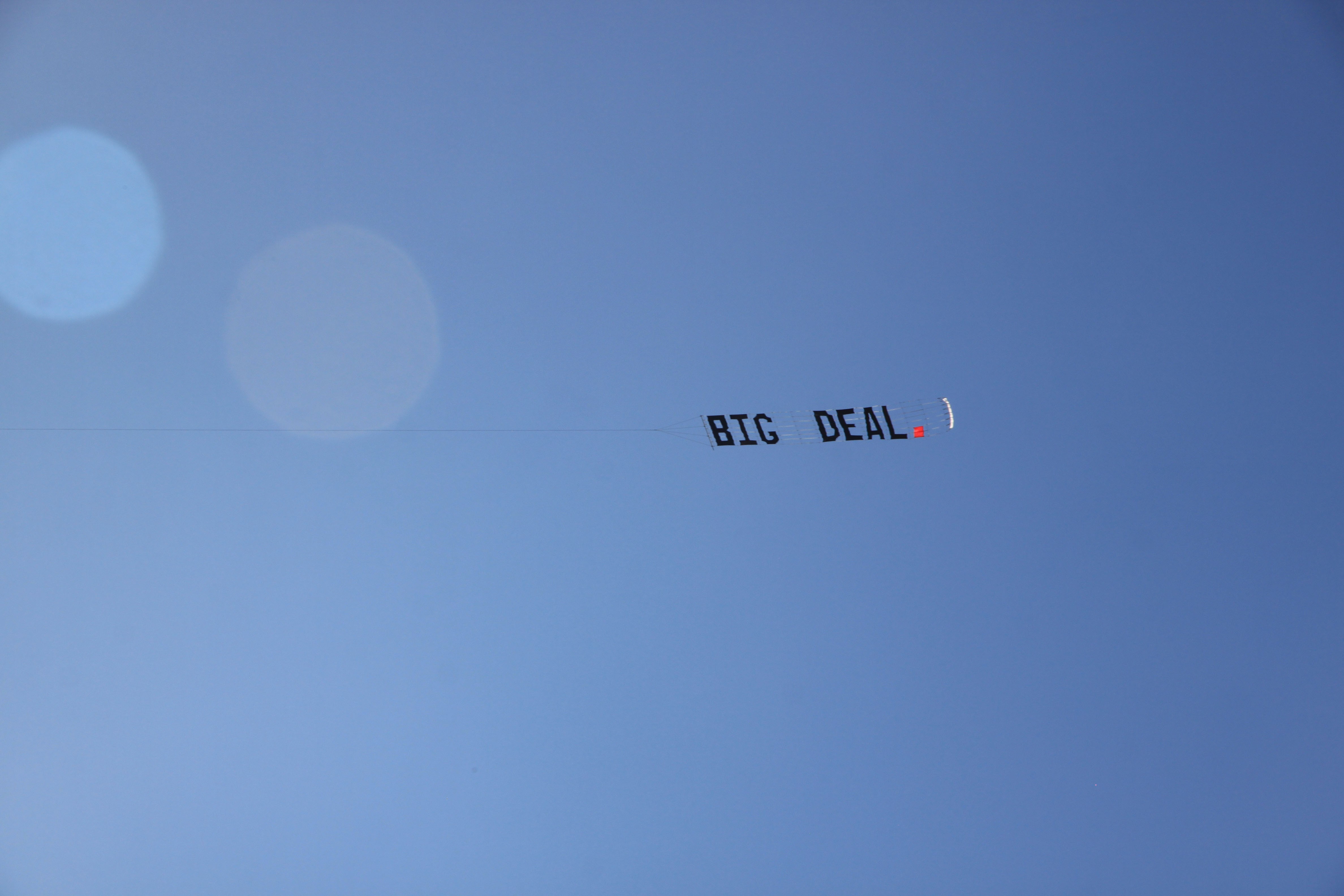 Photo of a banner that has the phrase 'BIG DEAL.' printed in black text and a red full stop. 