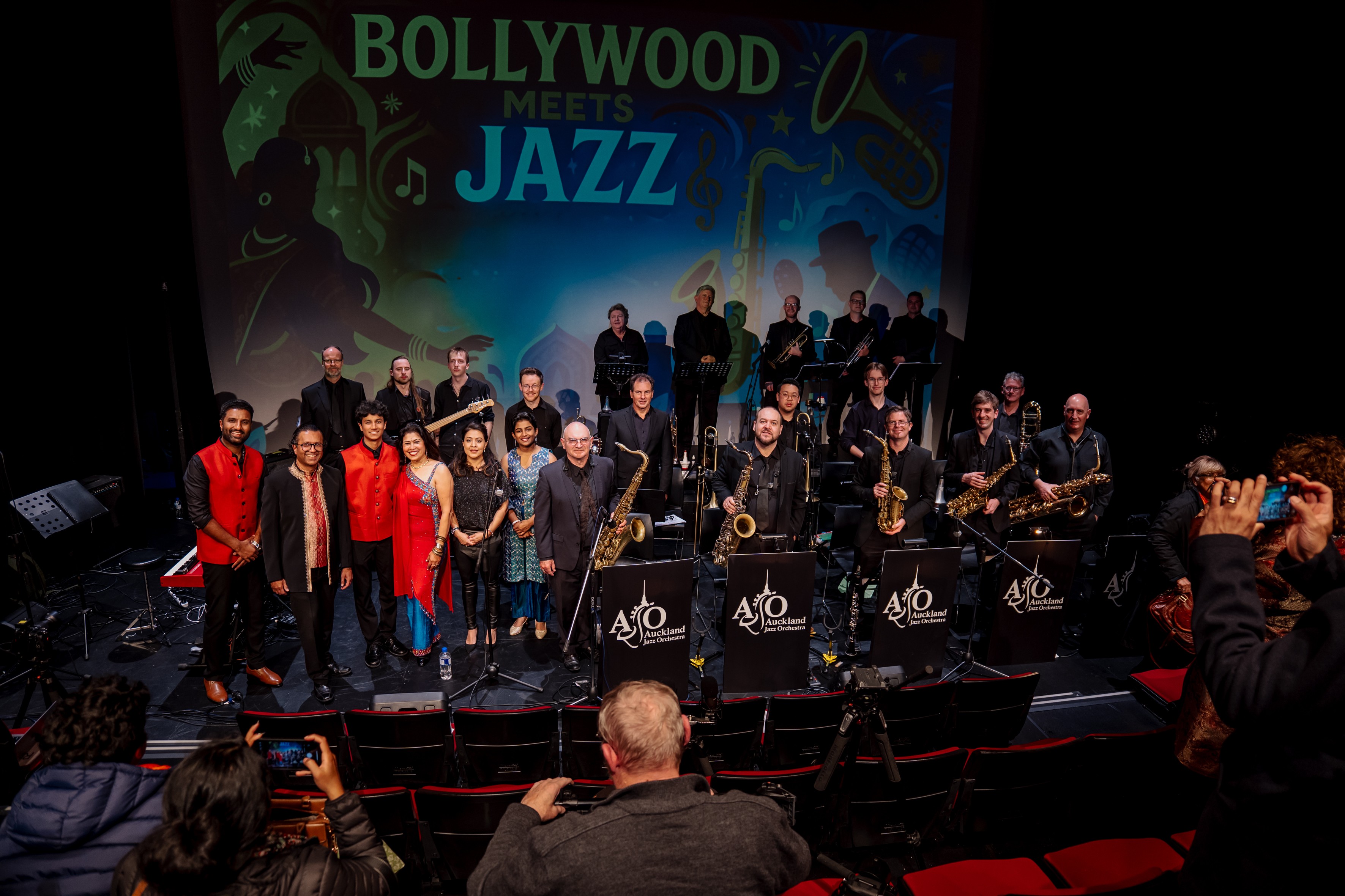 A large jazz band standing on a stage