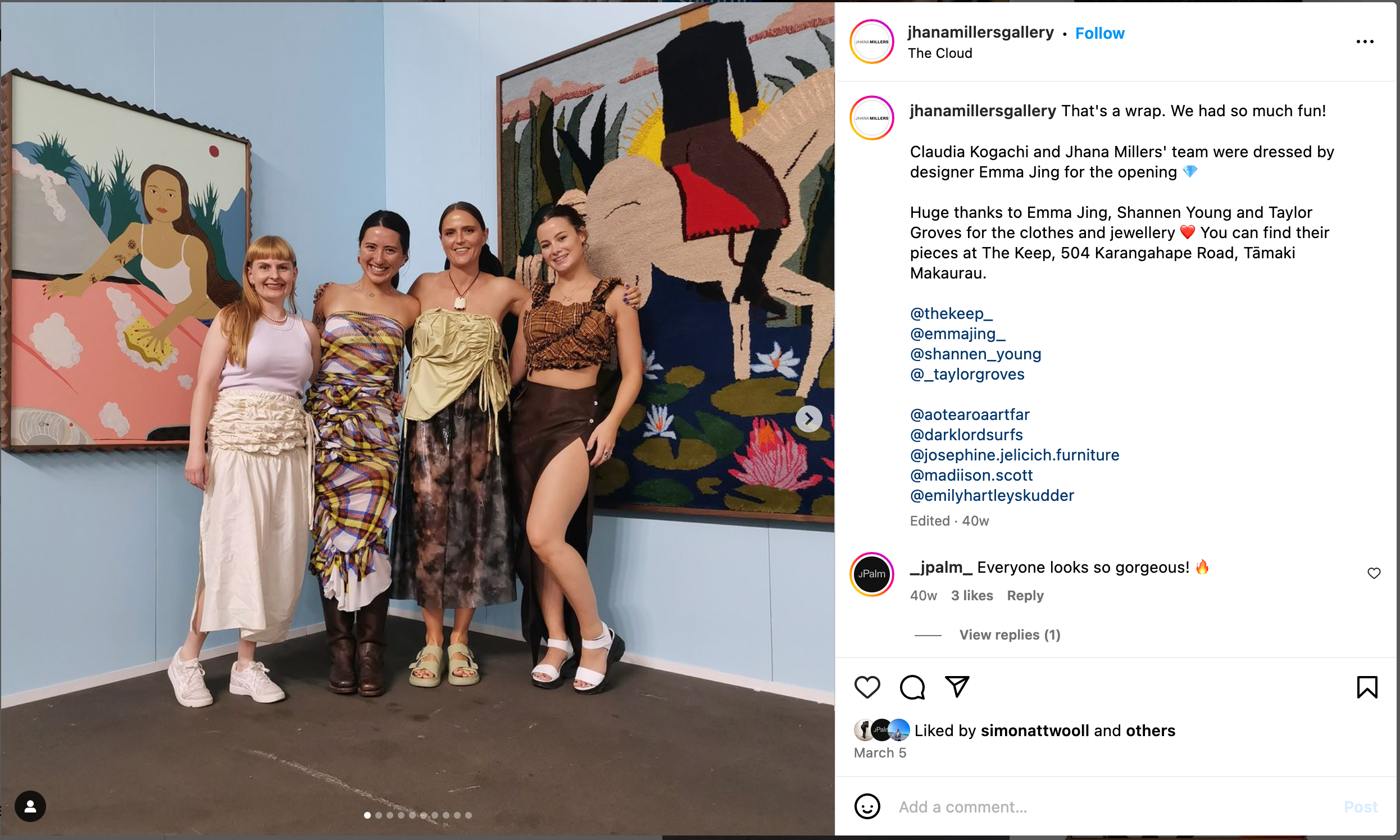 Four women wearing gathered and ruched garments stand in front of paintings in an art fair booth