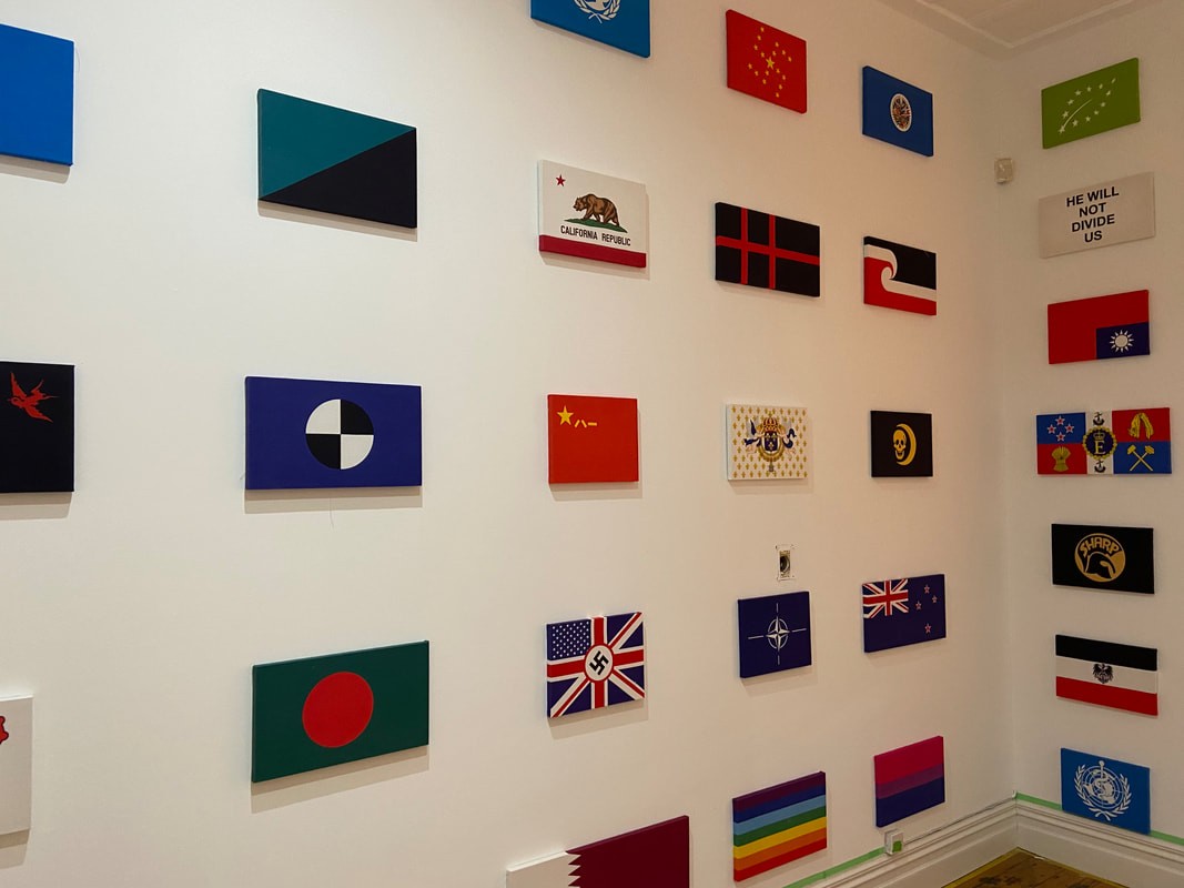 A wall with a grid of flags printed on canvases 