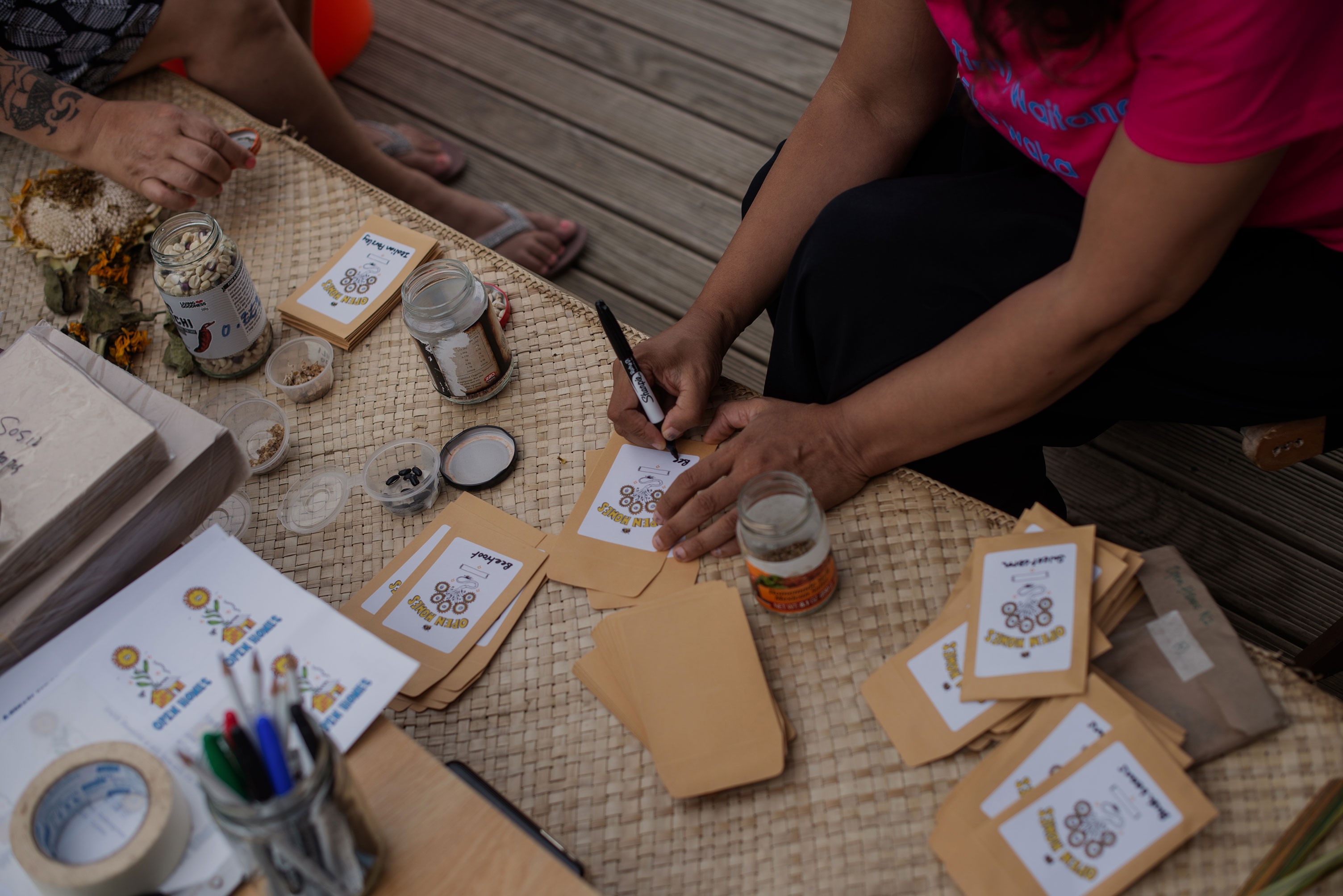 Seed packets on a woven mat being labelled properly