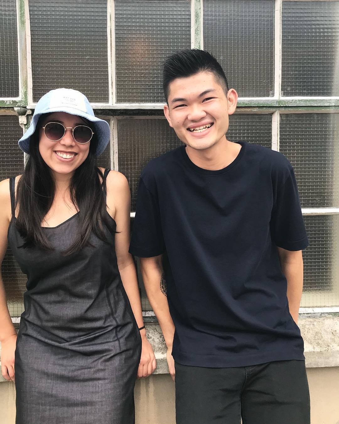 A man and a woman dresssed in black smiling at the camera