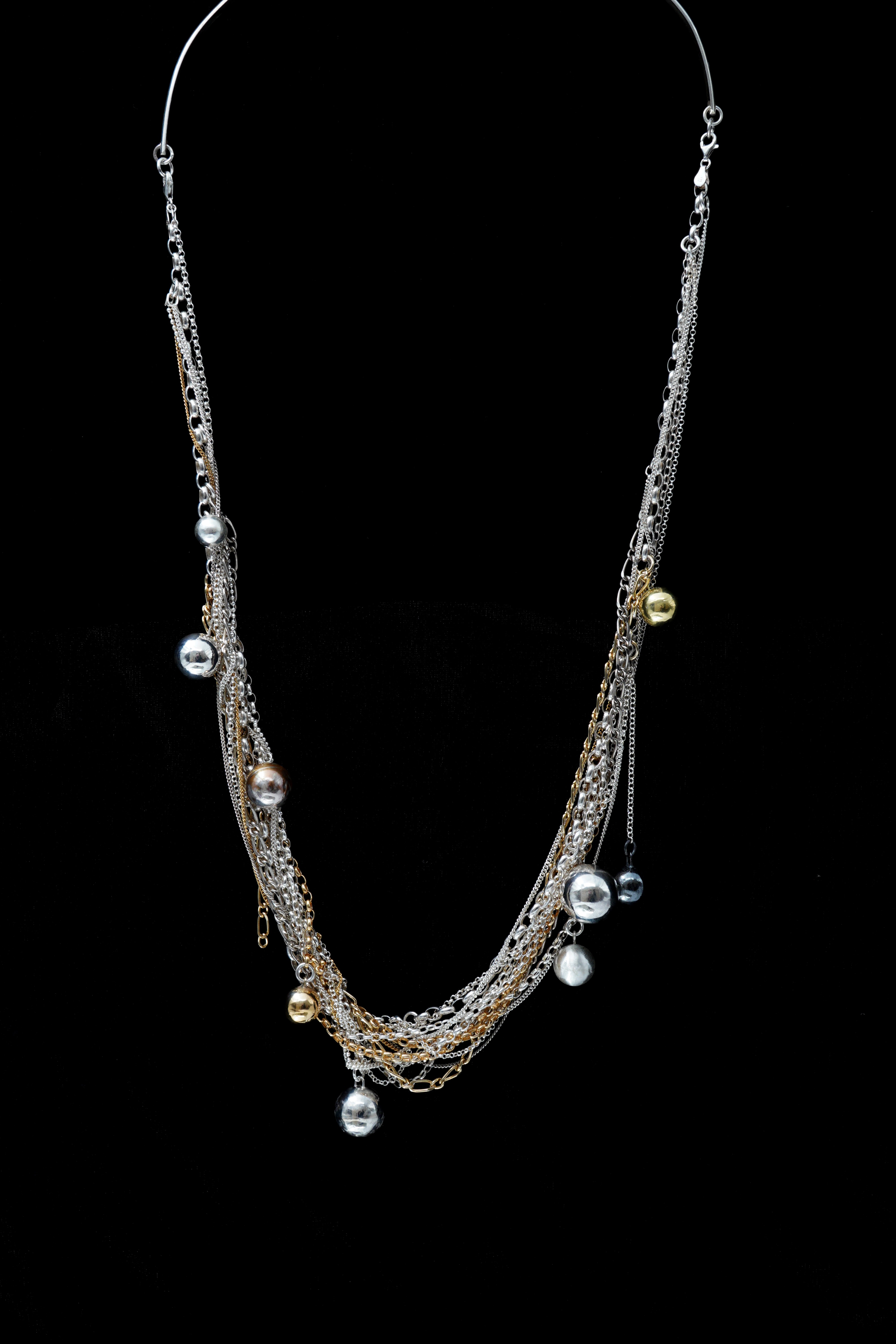 A necklace made of a series of delicate silver chains embellished with pearls