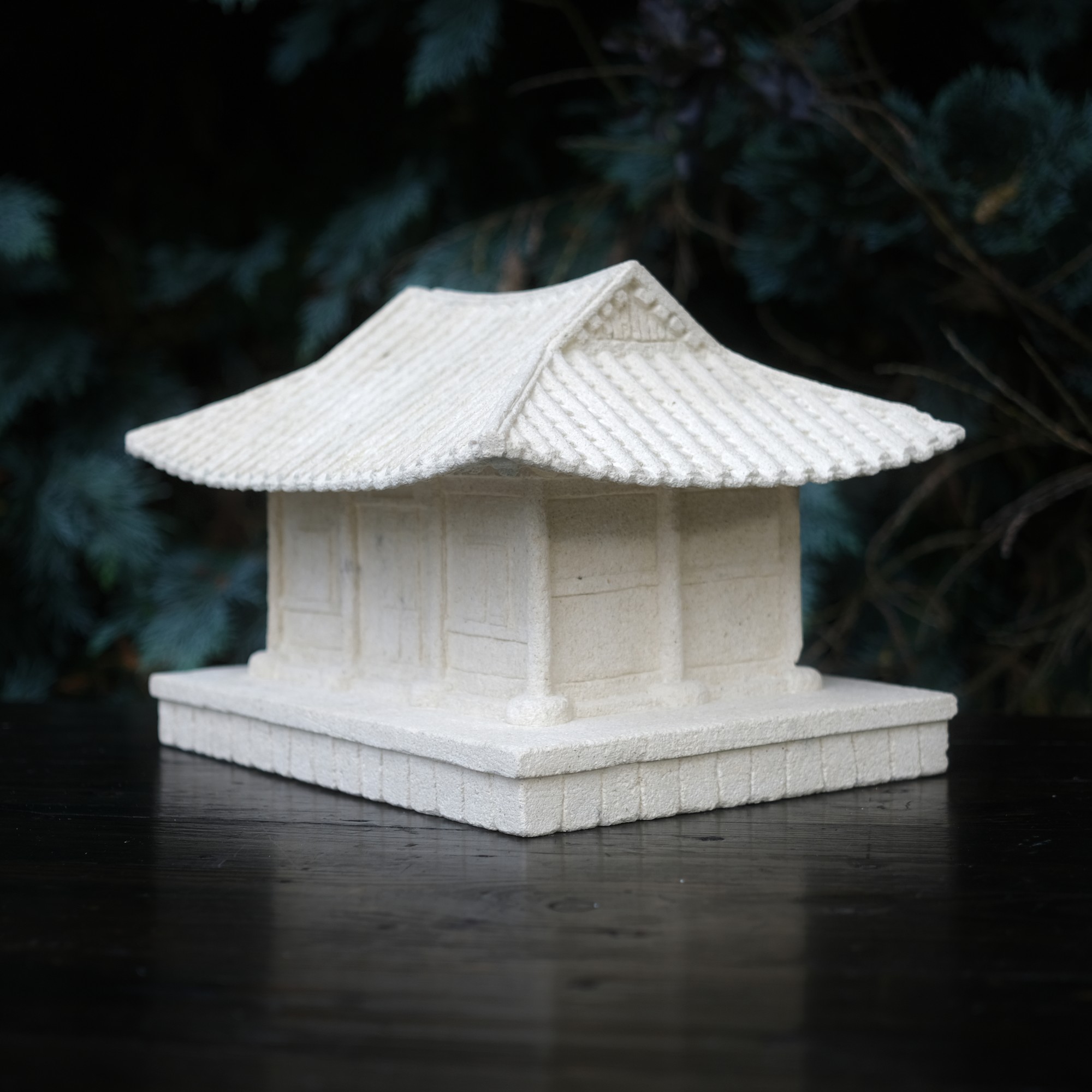 A jewellery box in the shape of a Korean house carved from limestone.