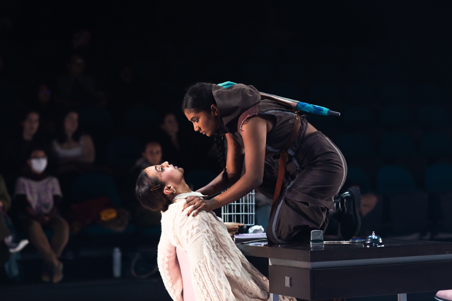 Two actors with an audience watching on.