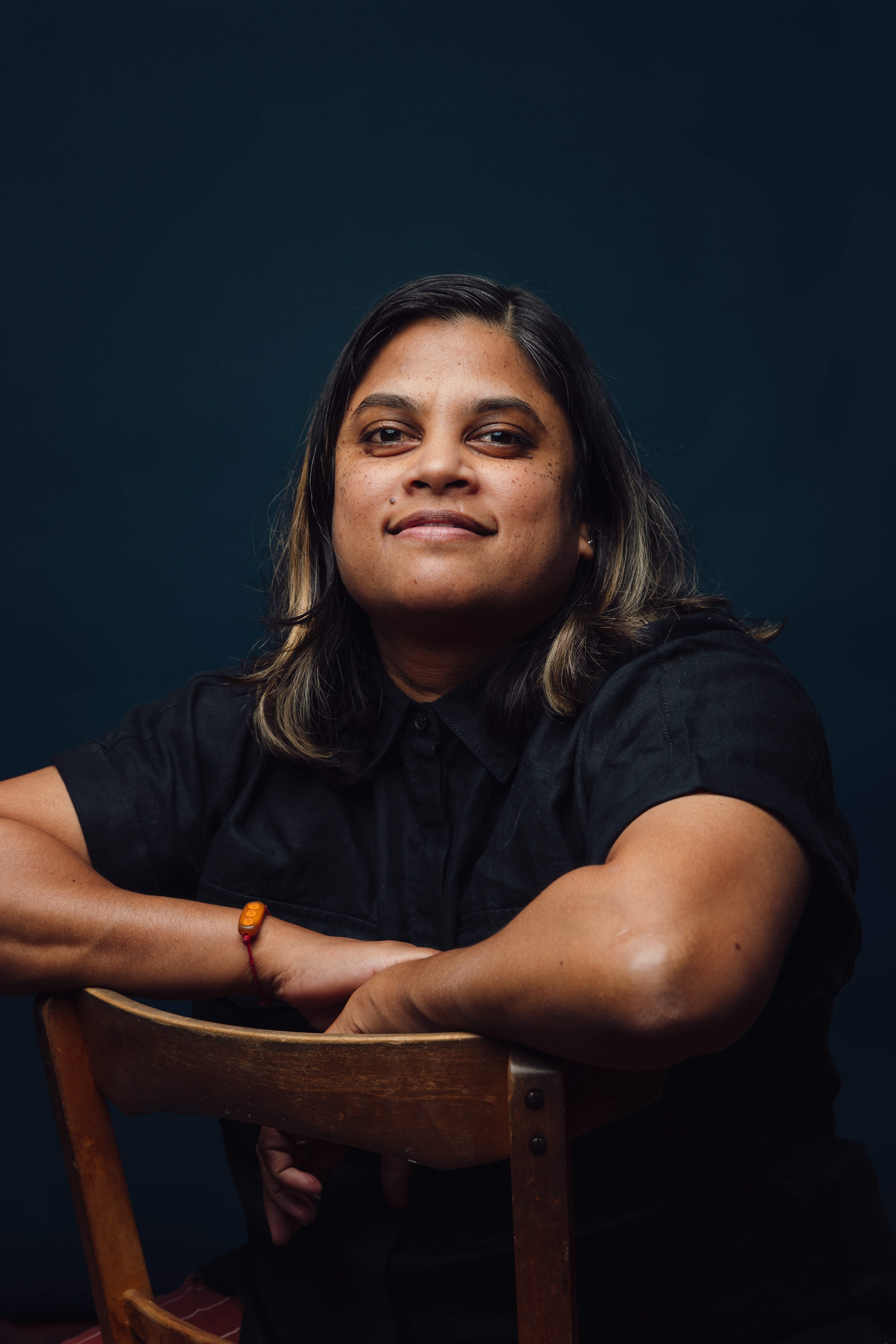 A person sitting in a chair and smiling