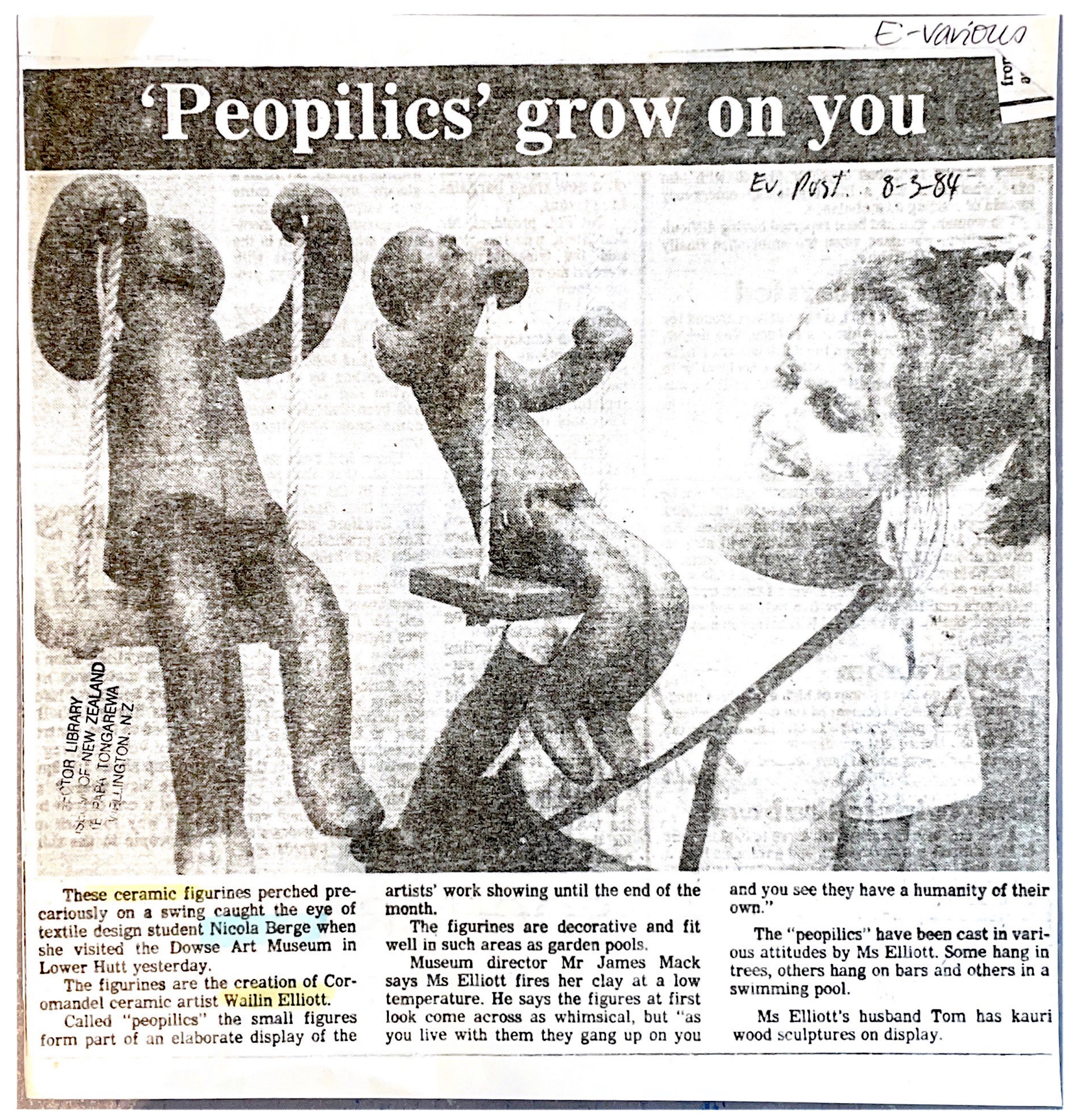 Newspaper clipping with a photo of a woman looking at two clay sculptures perched on swings.