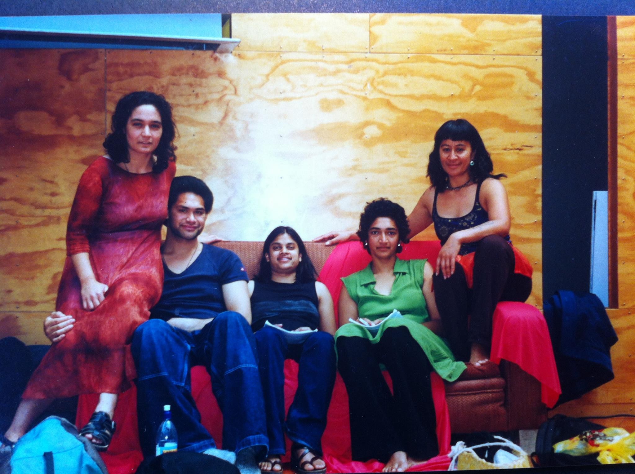 A group of people sitting on a red couch