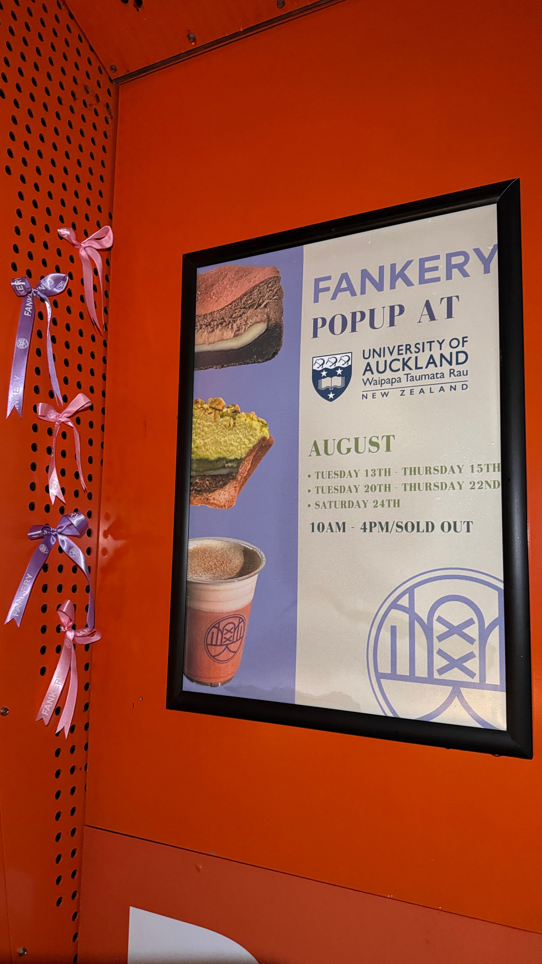 A poster with pictures of food and drinks hung on a red wall.