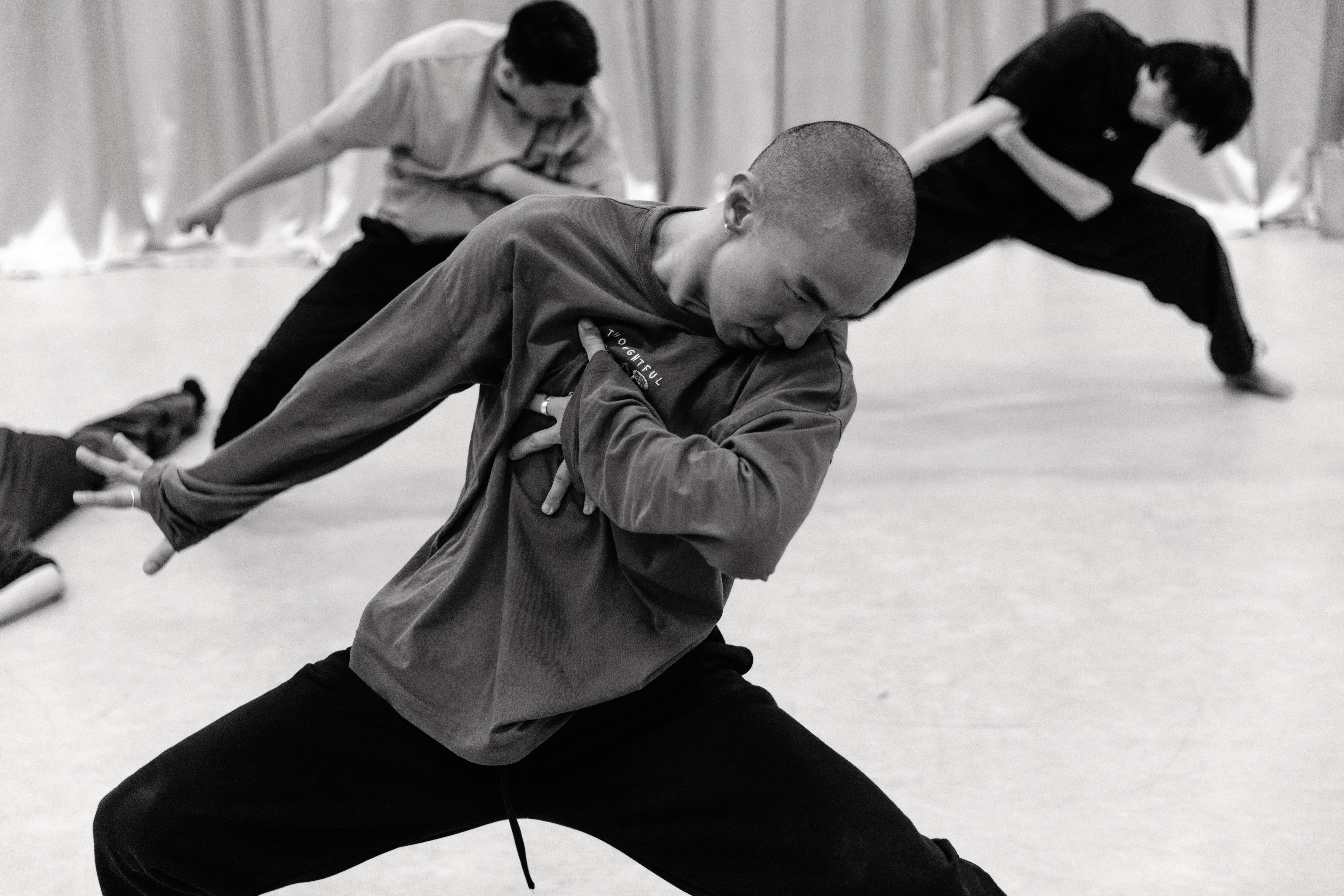 Dancers in casual clothes rehearsing.