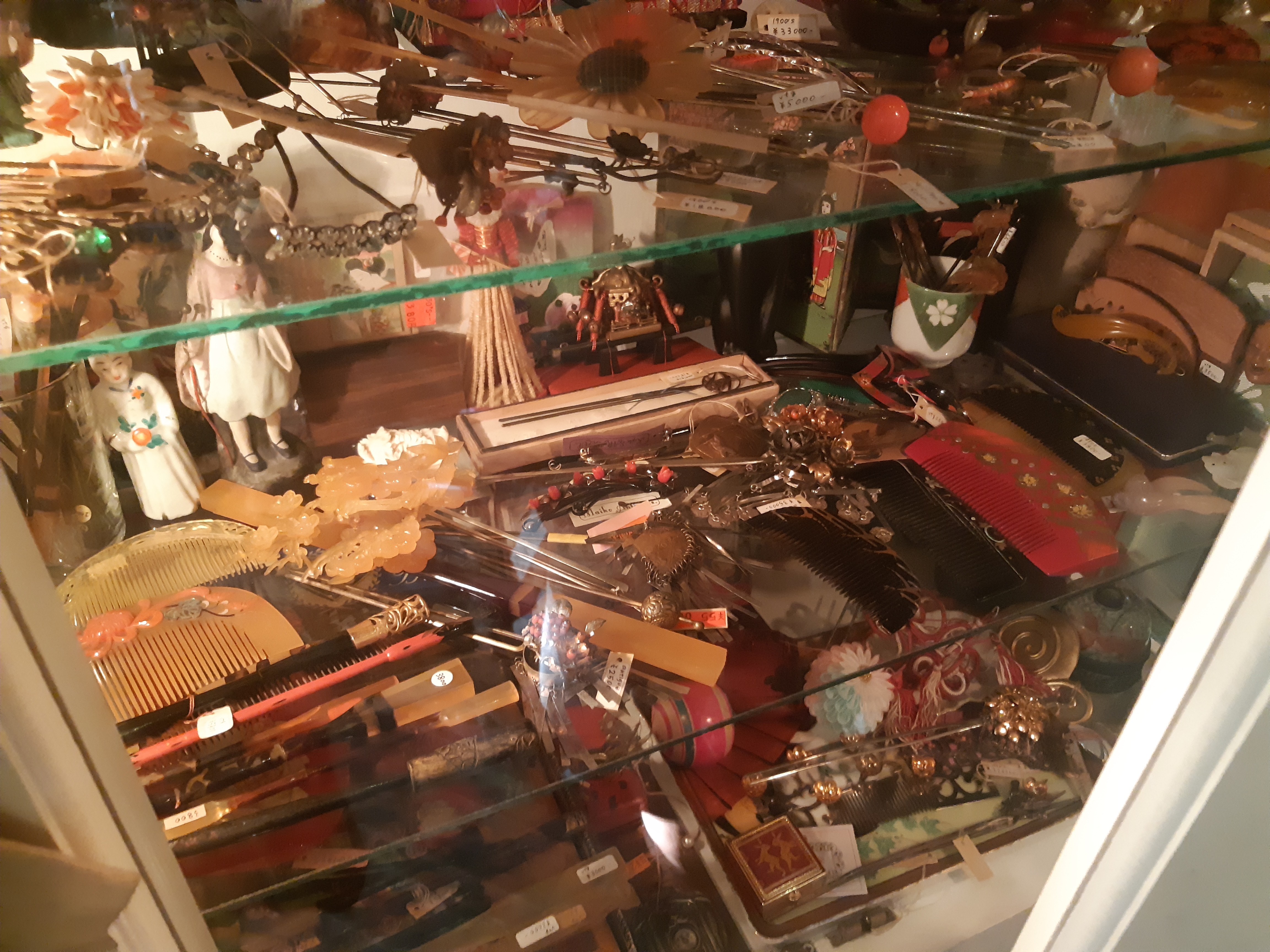 A glass cabinet filled with hair combs and hair ornaments