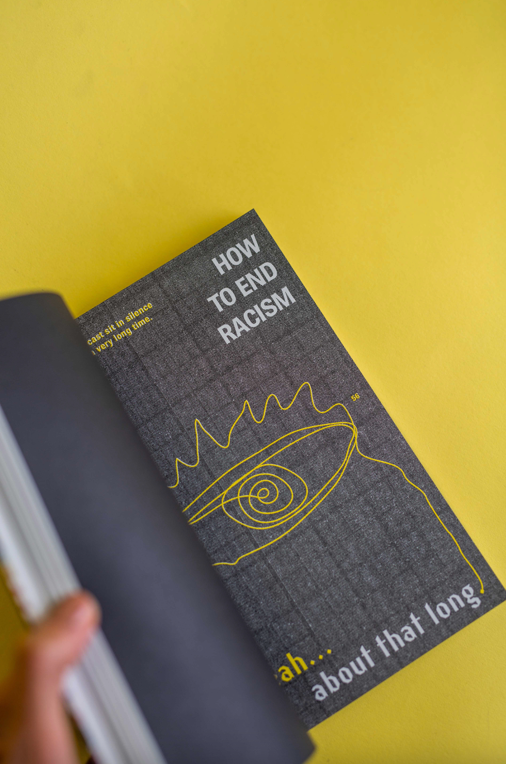 The spread of an open book with bold text design and an illustration of an eye. 