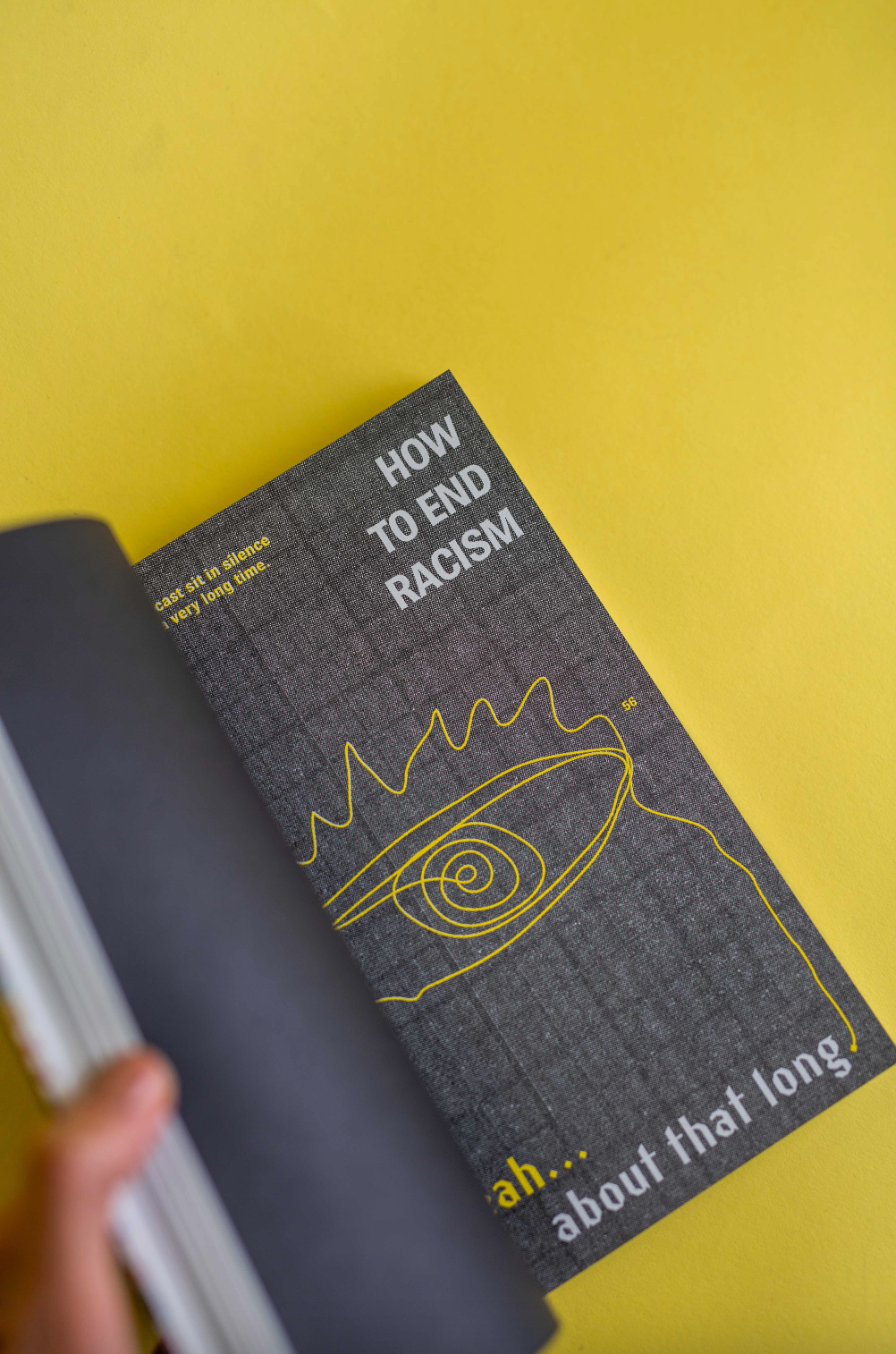 The spread of an open book with bold text design and an illustration of an eye.
