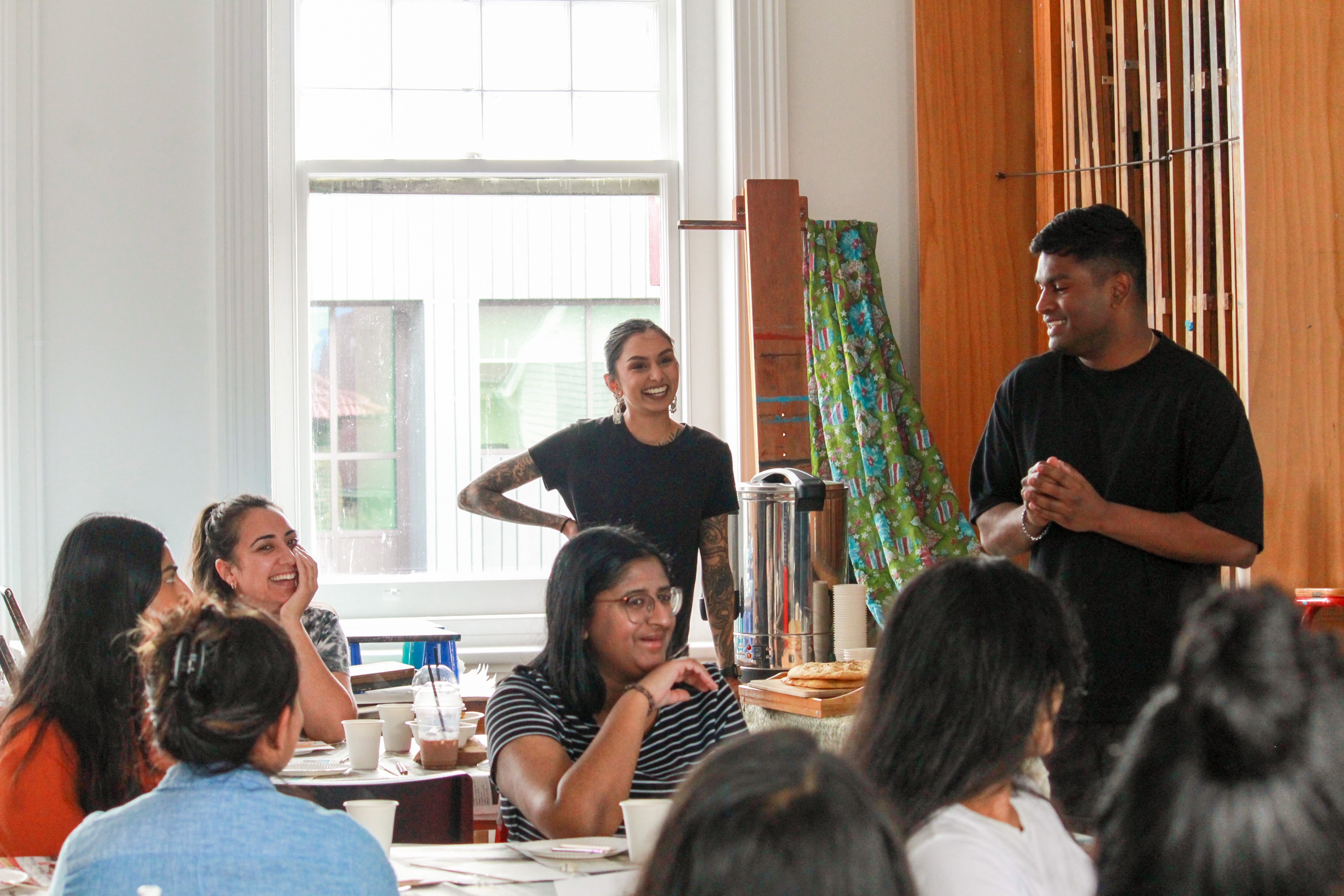 People sitting and standing in a bright room