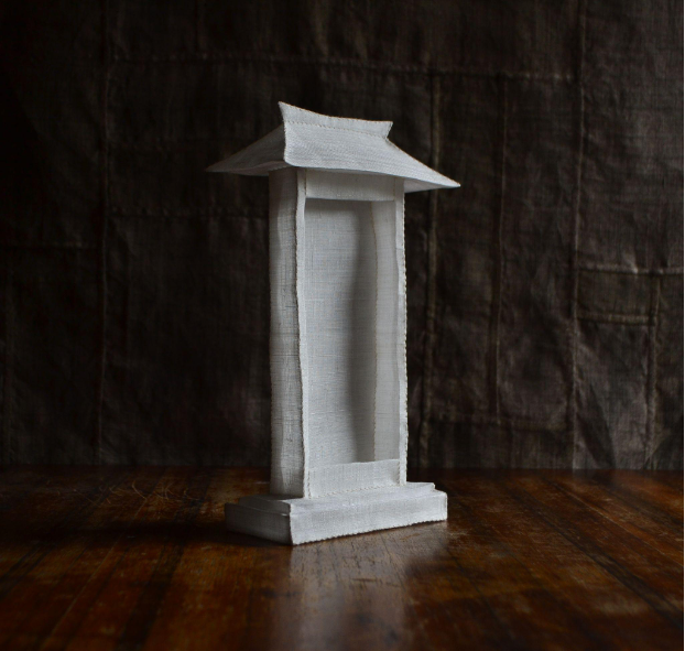 Small sculpture of a Korean-style house made from fabric.