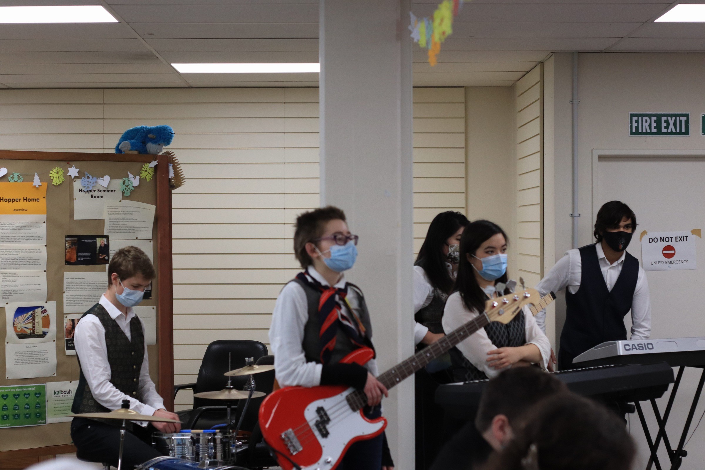 A band of five students in school uniform, wearing masks