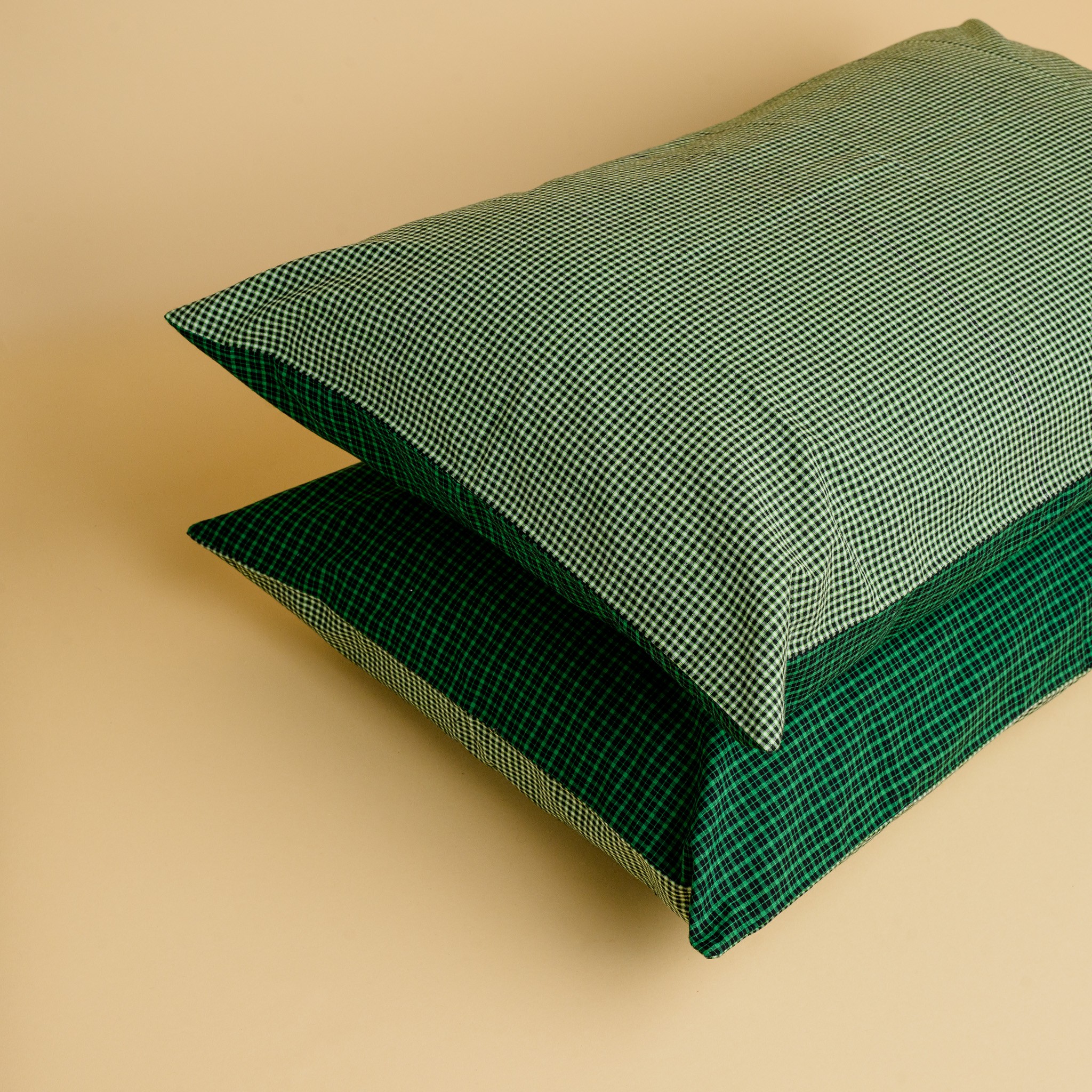 Two green pillowcases with checked detail