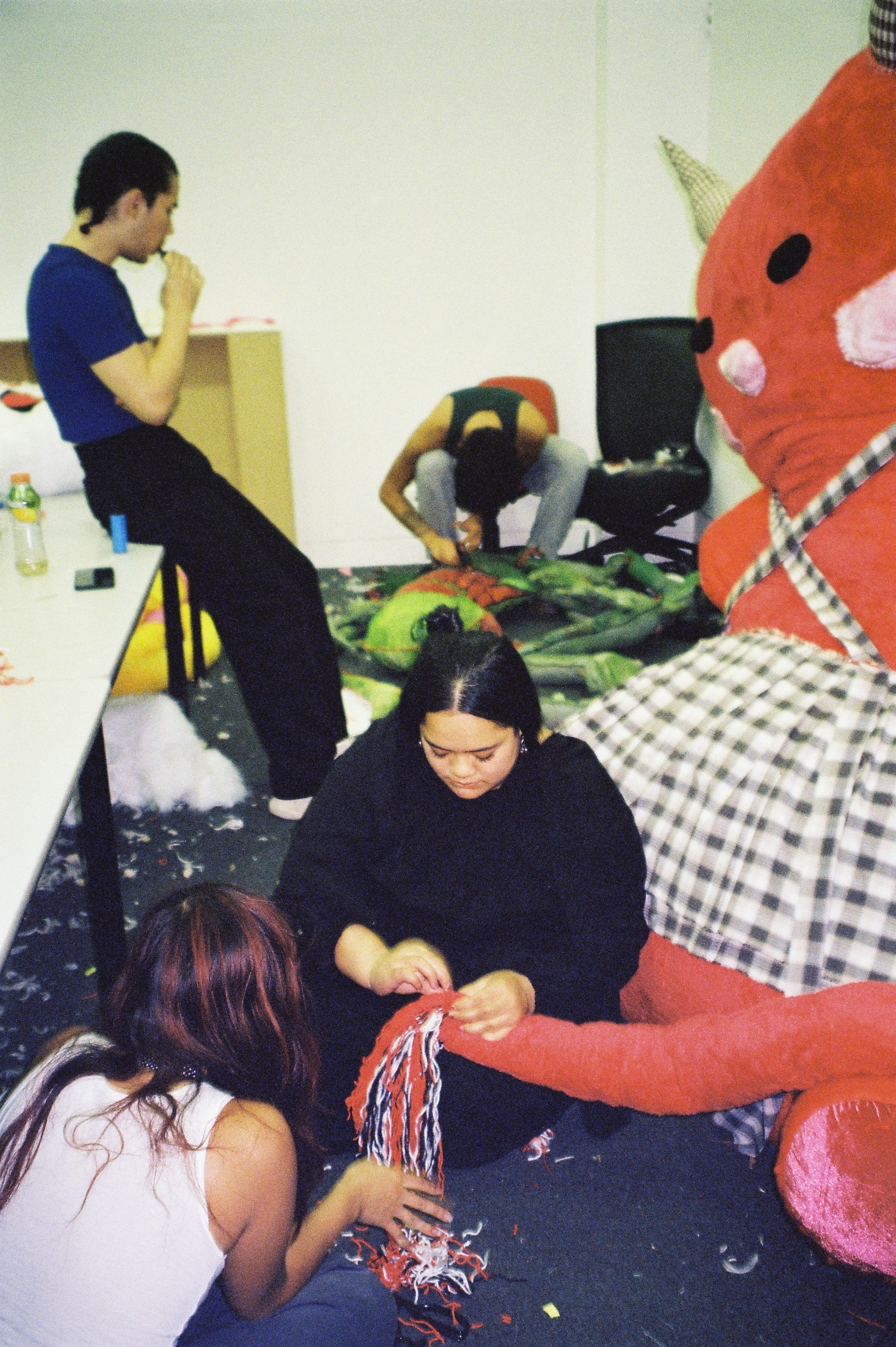 A group of people sewing in a room