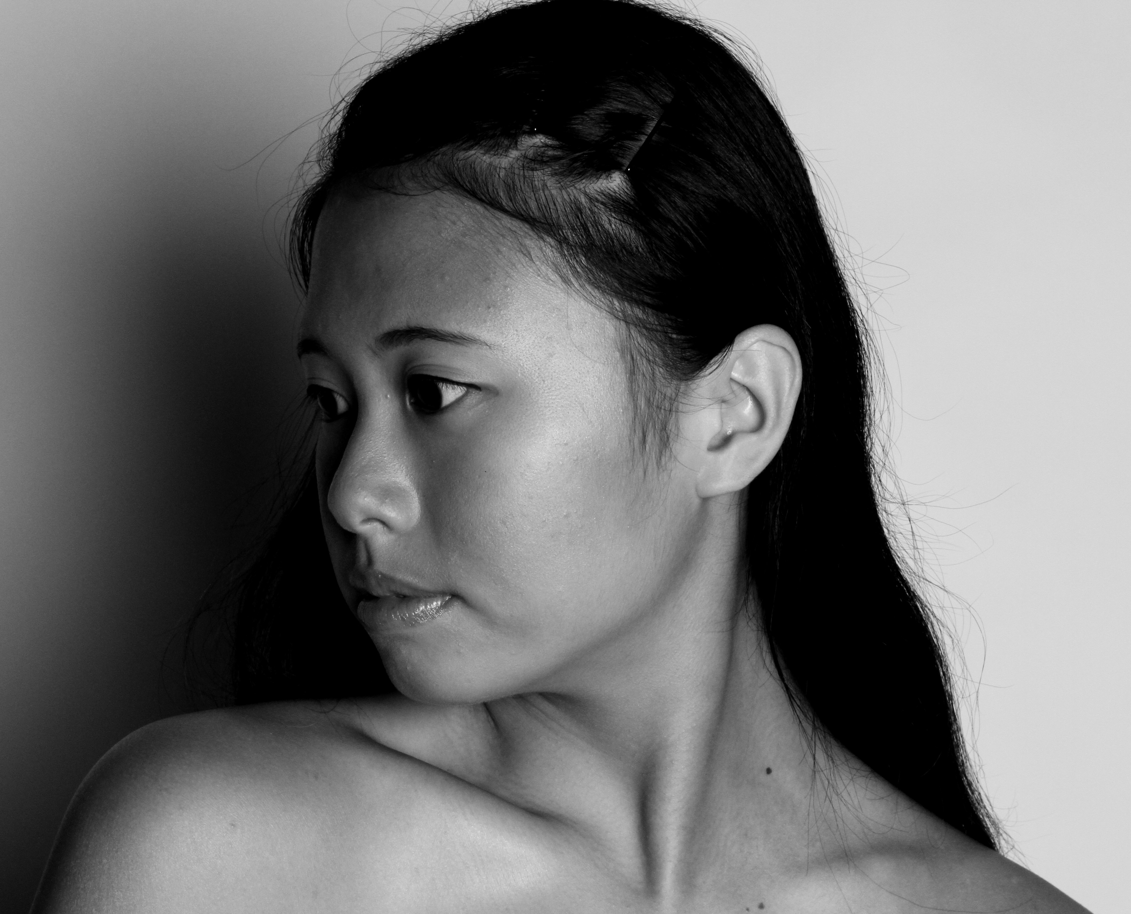 A black and white close-up photo of an Asian woman.