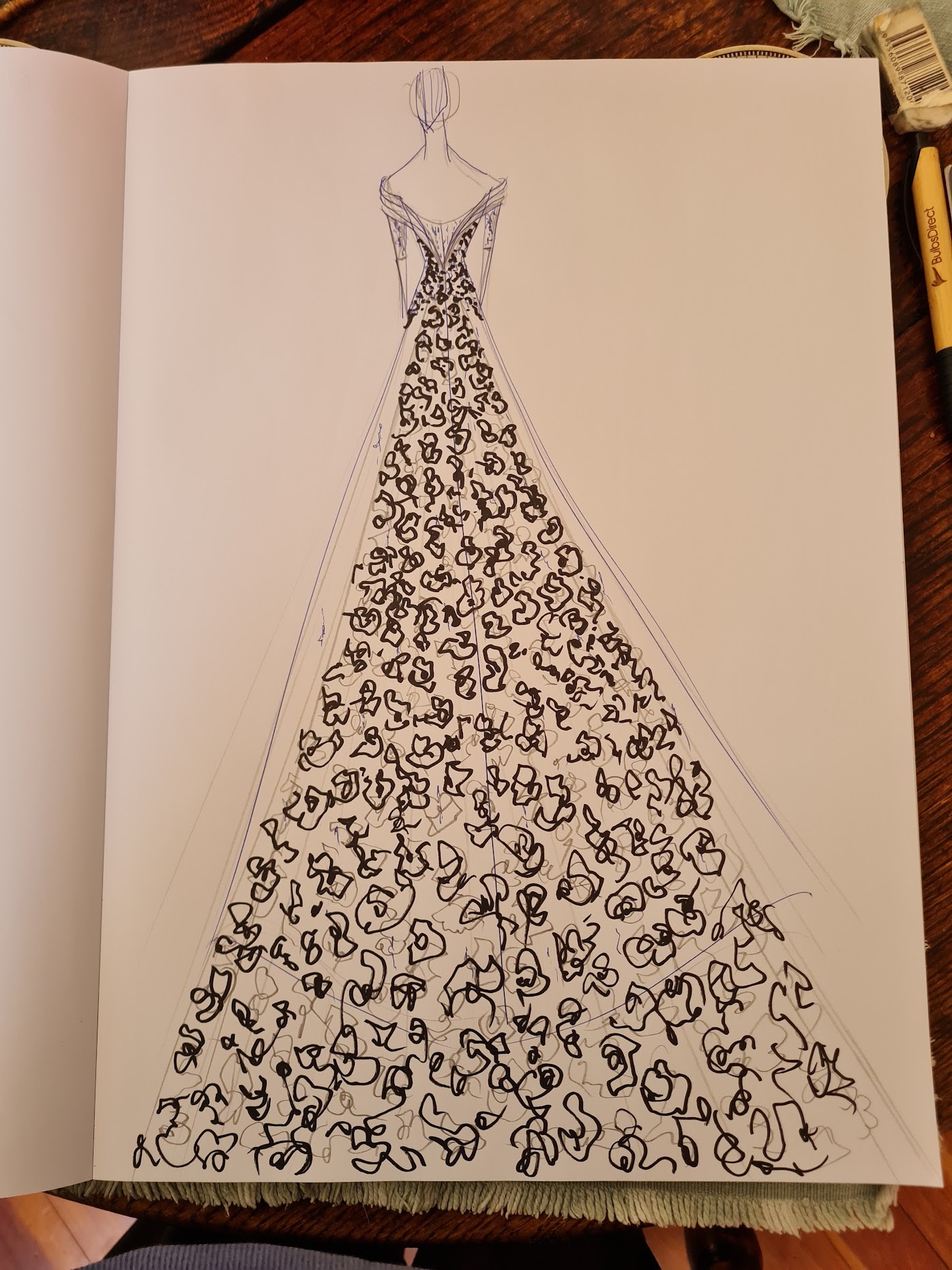 A fashion illustration of a long flowing gown festooned with ornate lacework