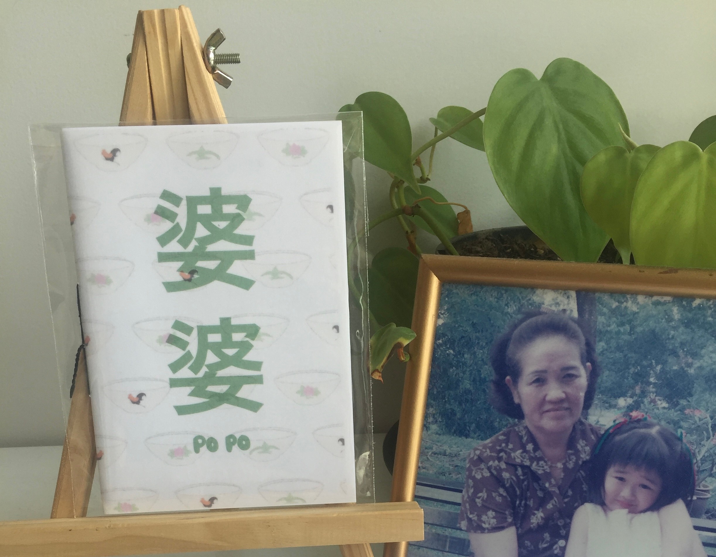 The zine next to a photograph of a grandmother and granddaughter 