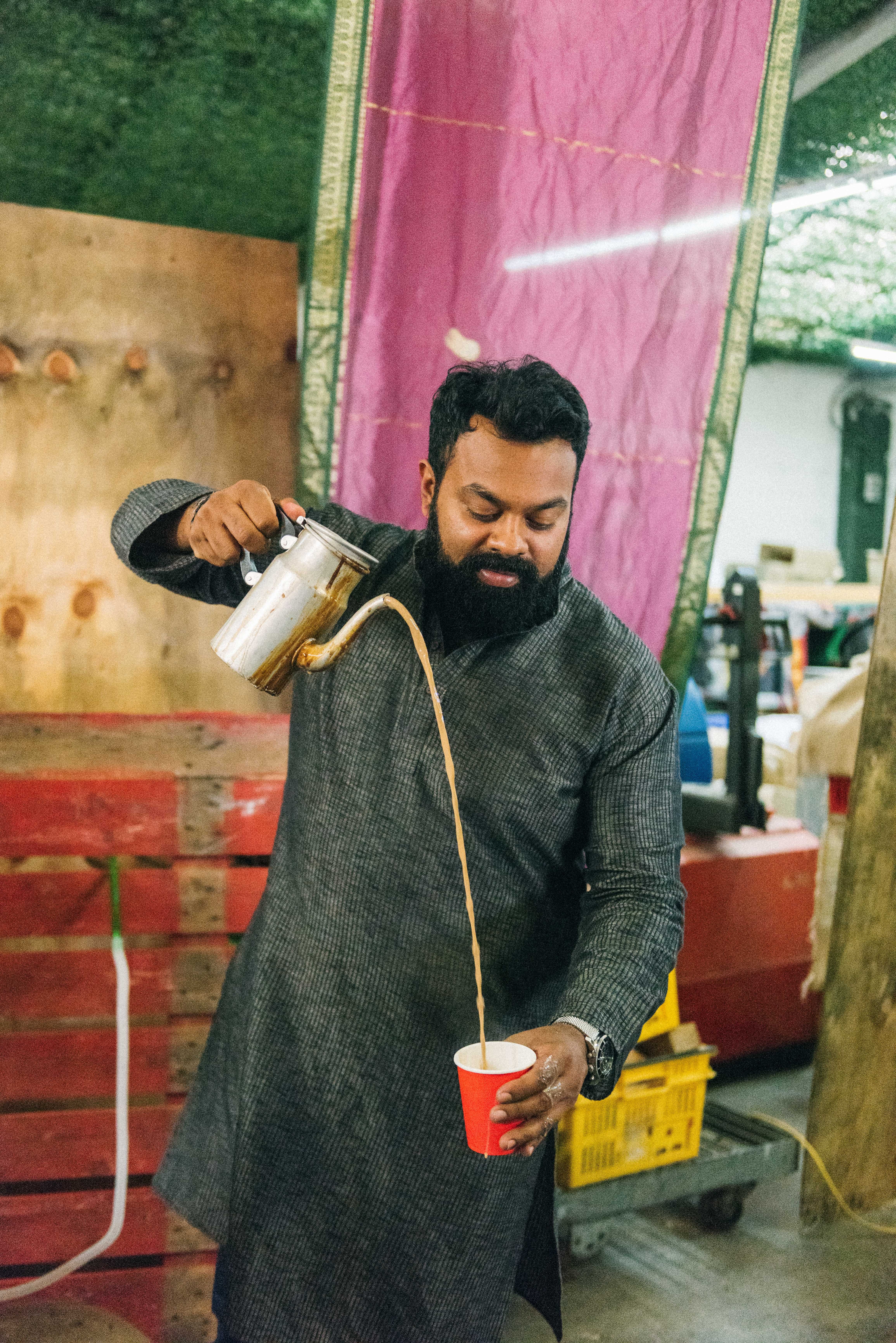 A man pouring tea from a height