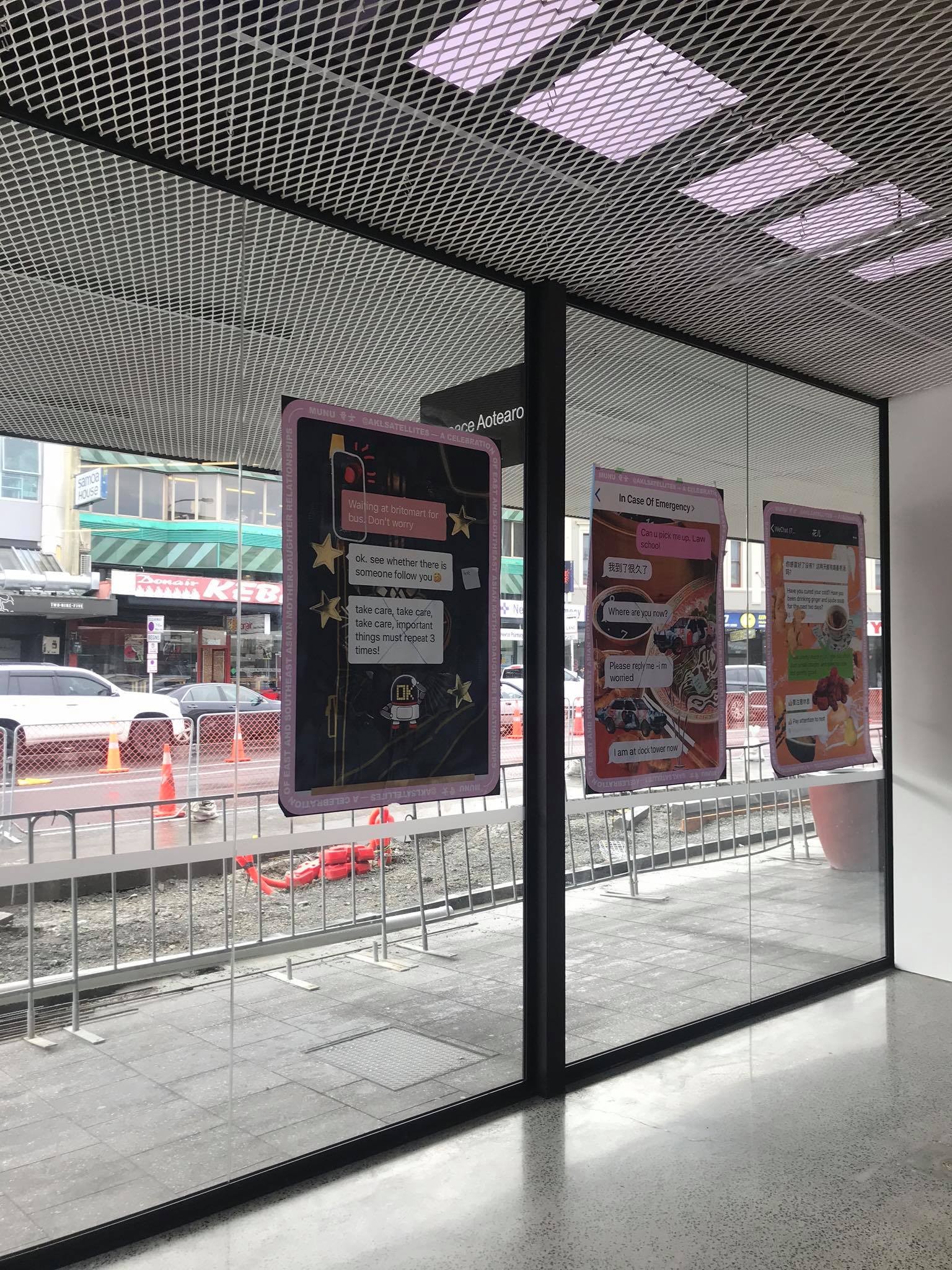 Posters on a window, facing out into Karangahape Road.