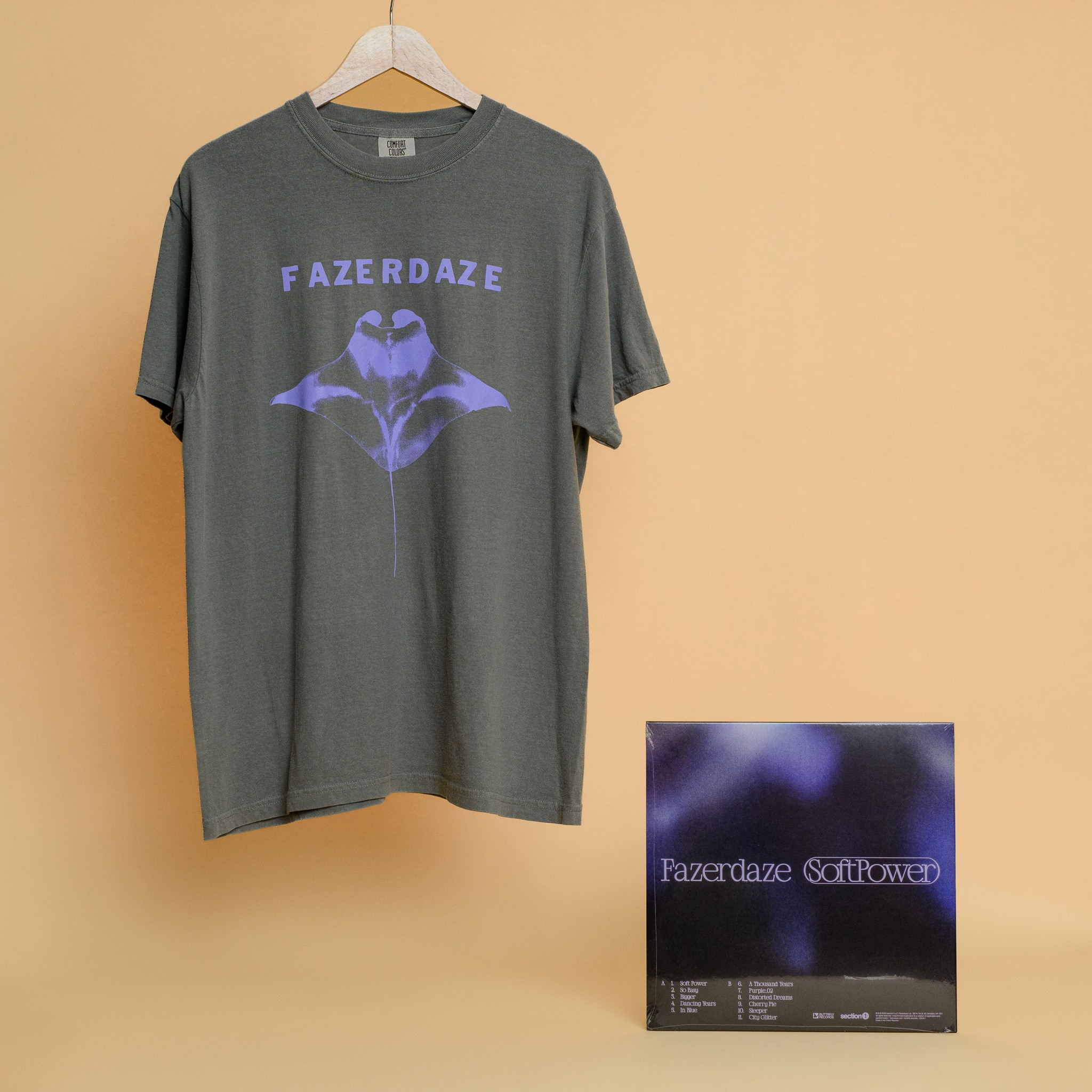 A grey t-shirt with lilac detailing and a matching album