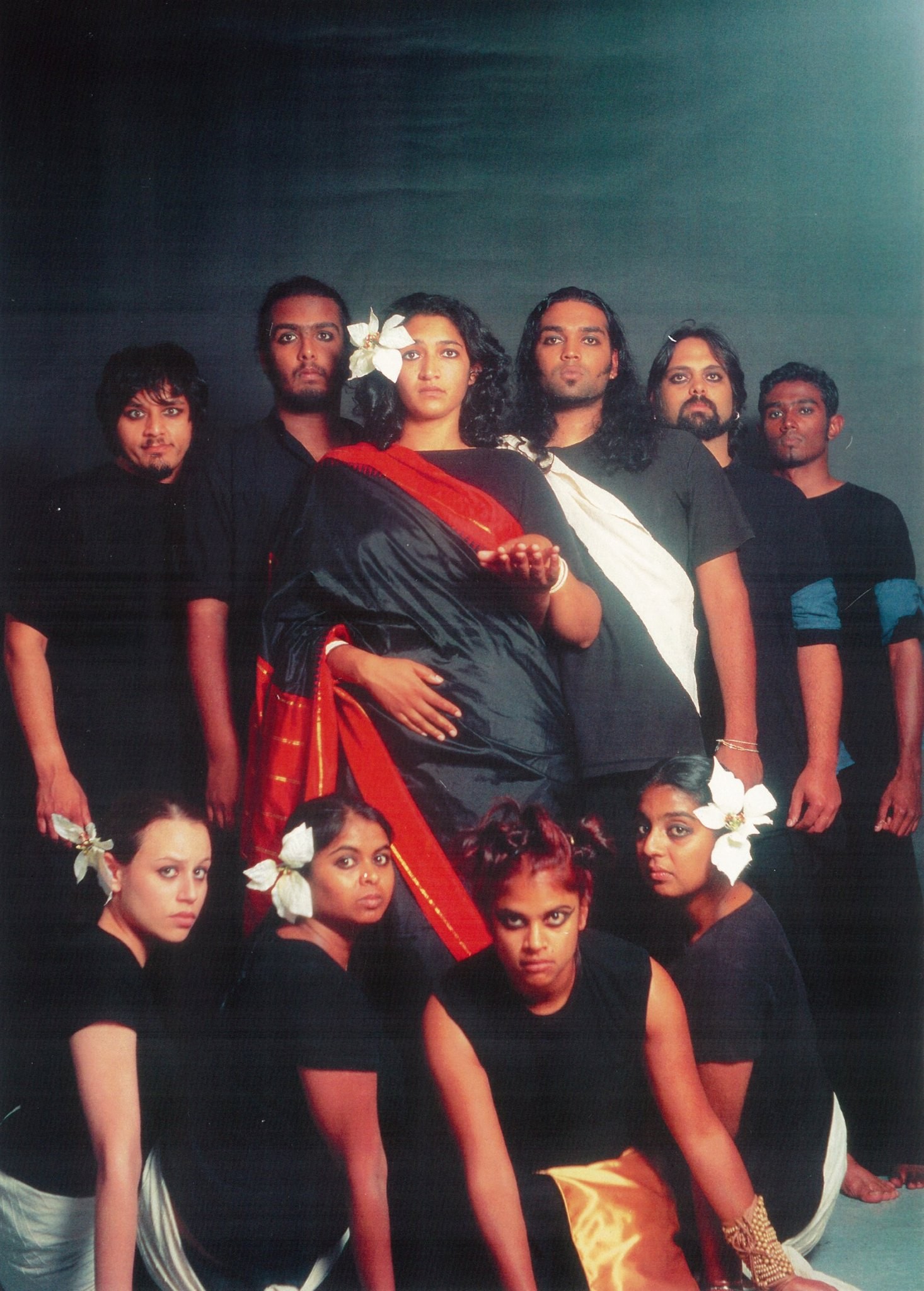 A group of people standing in a group and facing the camera