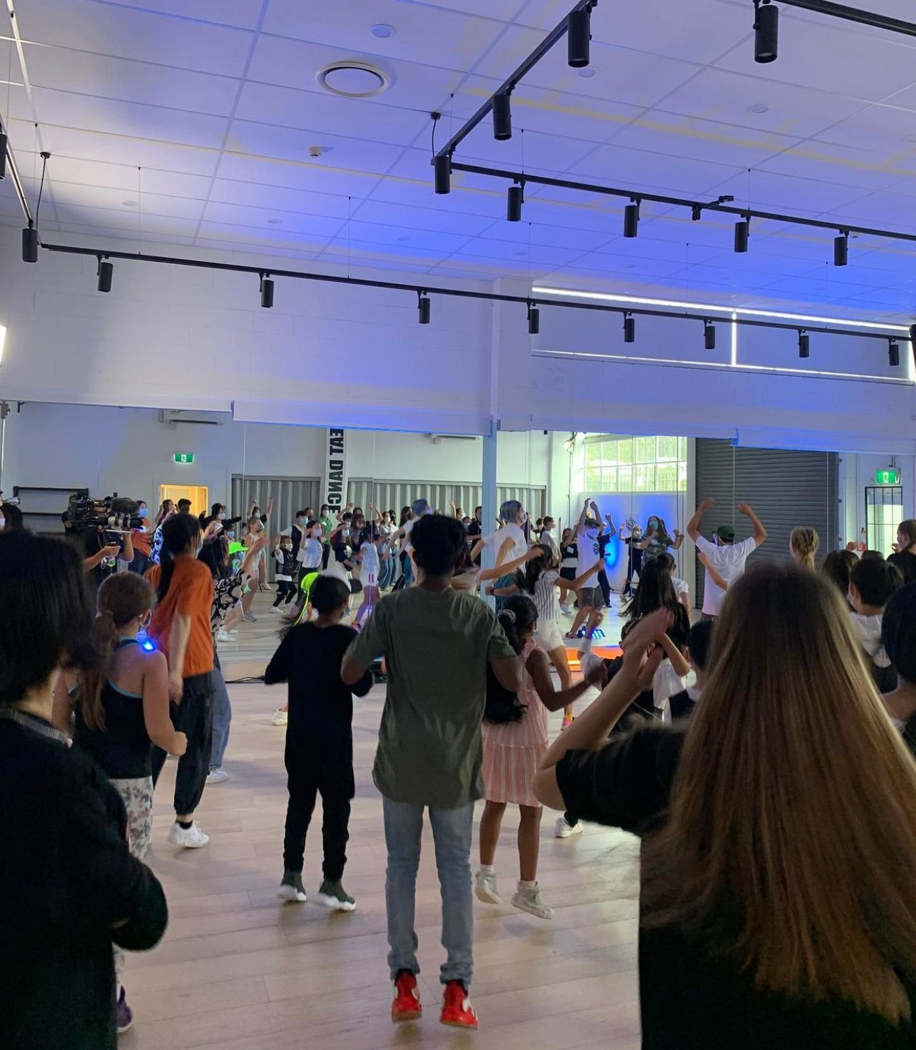 A group of young people in a dance studio taking a dance class