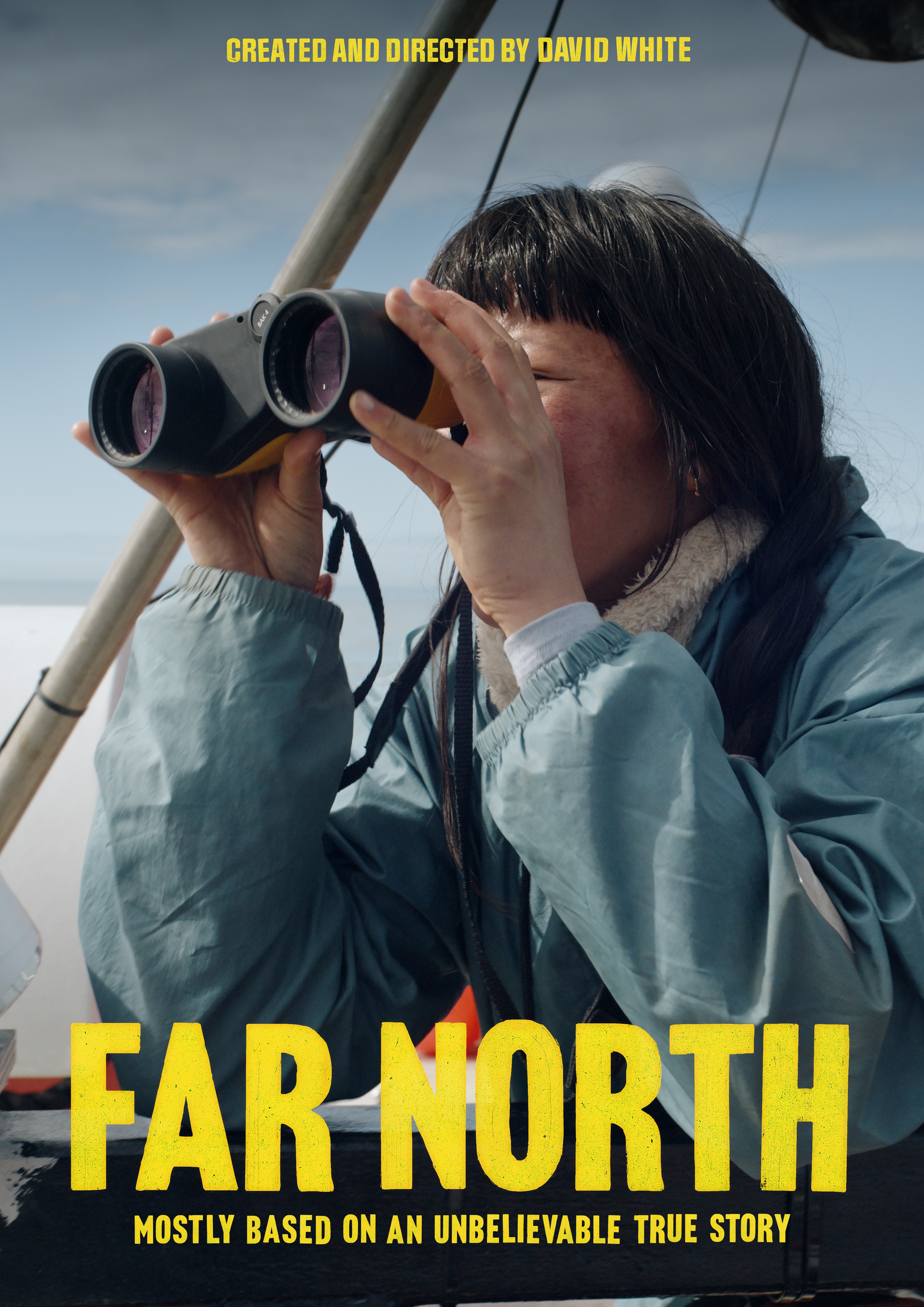 A woman looking through binoculars wearing a blue rain jacket