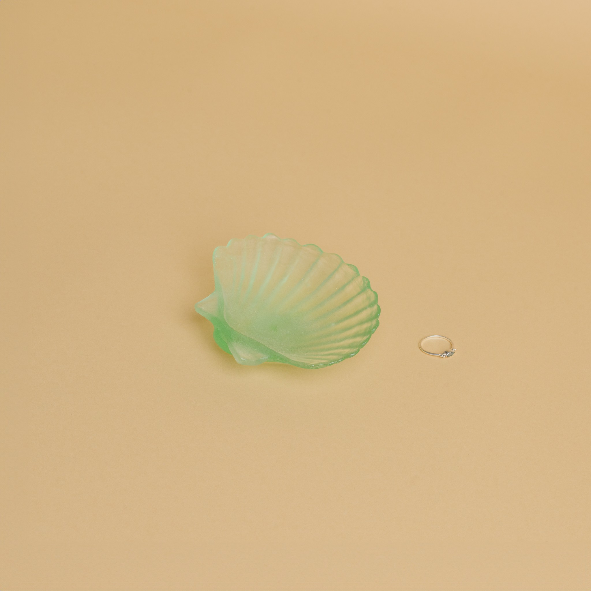 A bright green glass scallop shell 