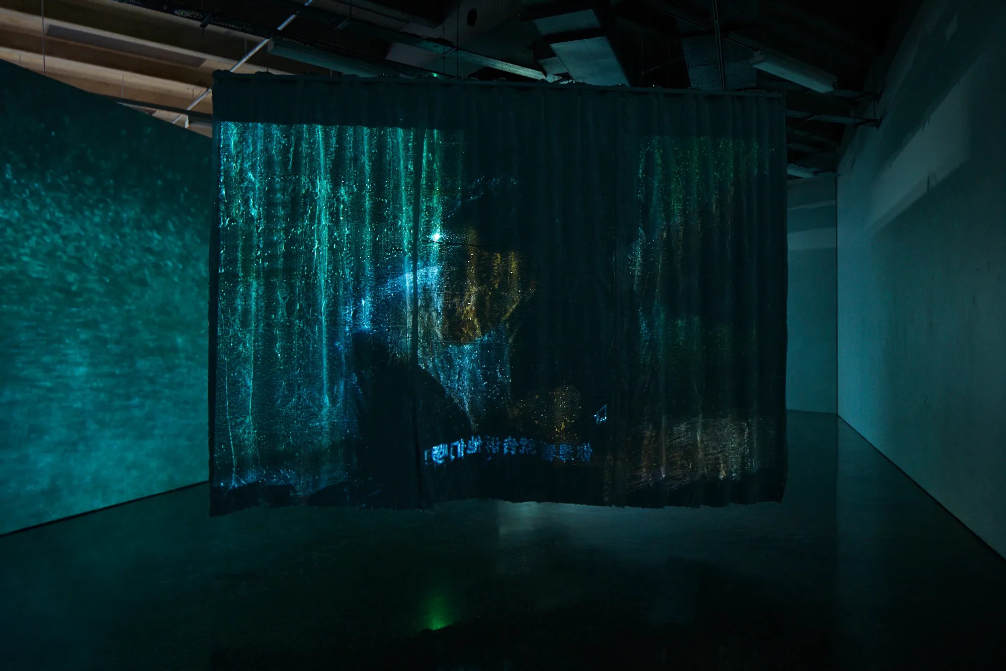 A shimmering curtain with a projection on it