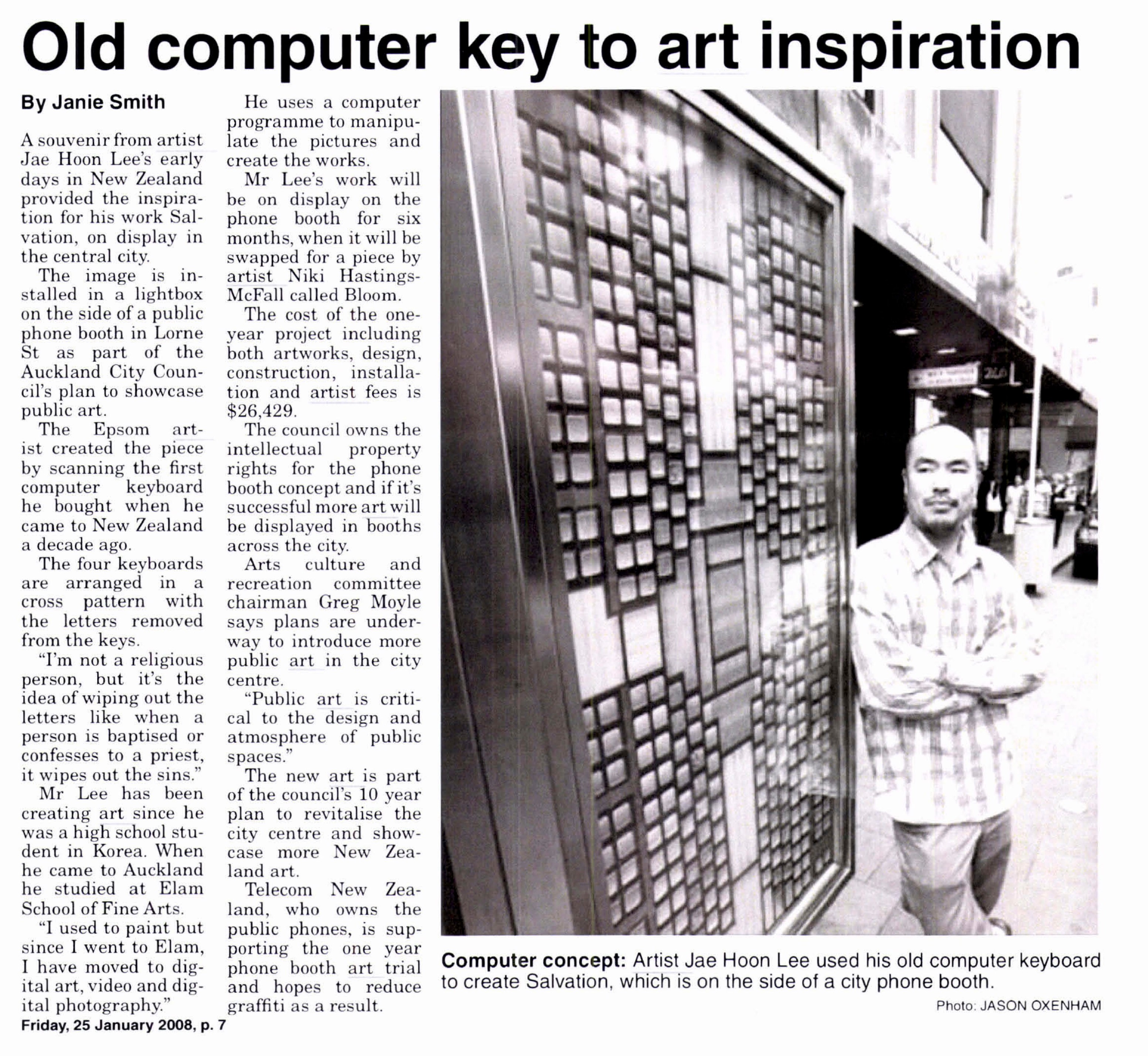 Newspaper clipping with photo of the artist leaning against a telephone booth with their computer keyboard artwork displayed inside.