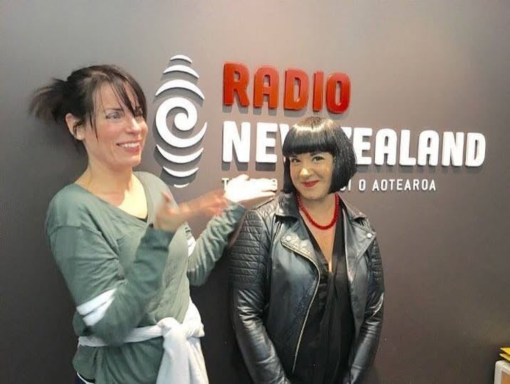 Two people standing in front of a wall at Radio New Zealand