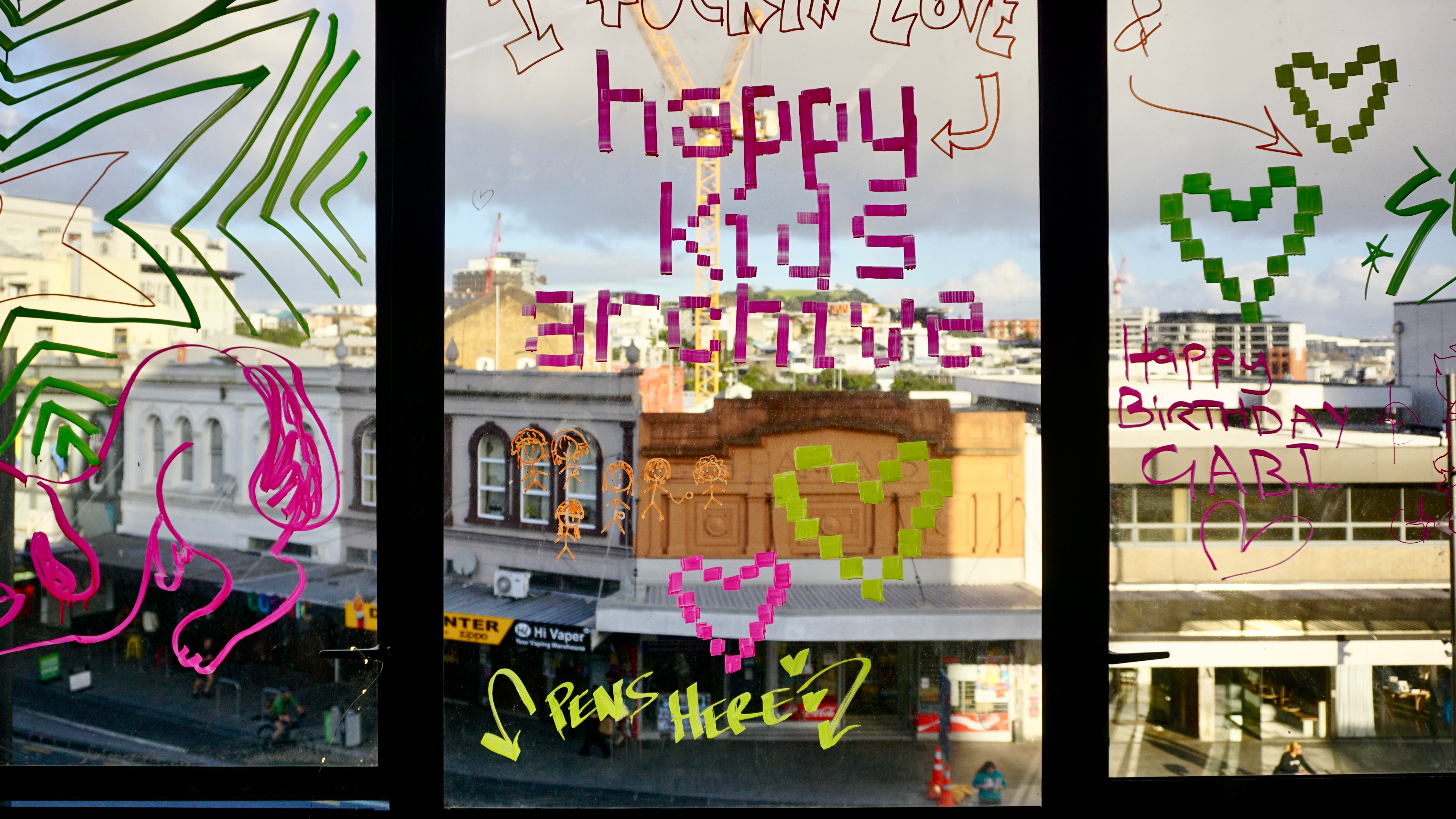 Colourful drawings adorn windows looking out into K Road.
