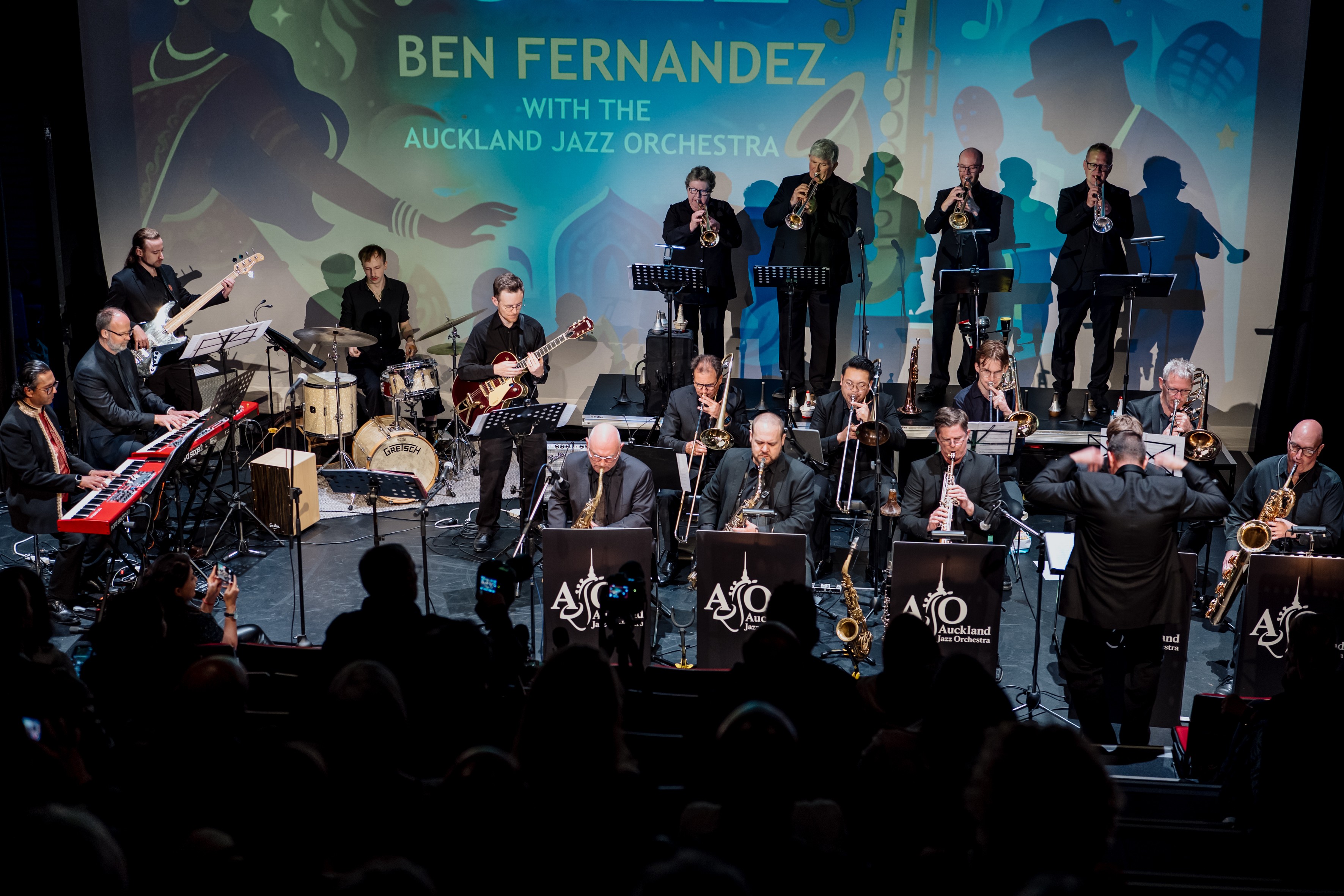A large jazz band playing on a stage