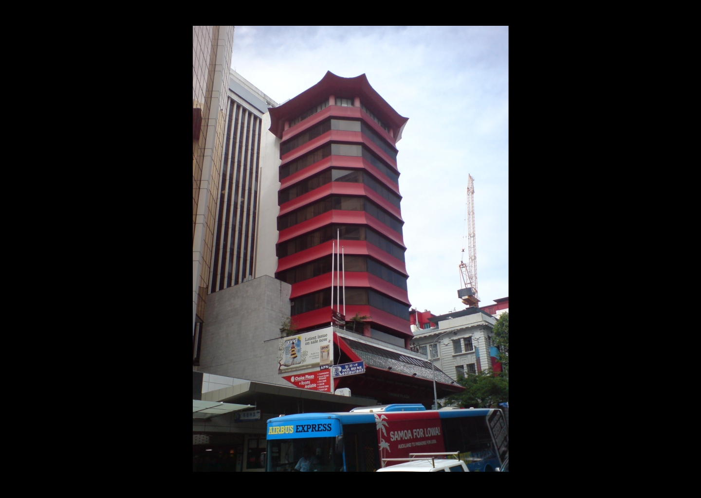 Photograph of a tall red and black pagoda-topped tower.