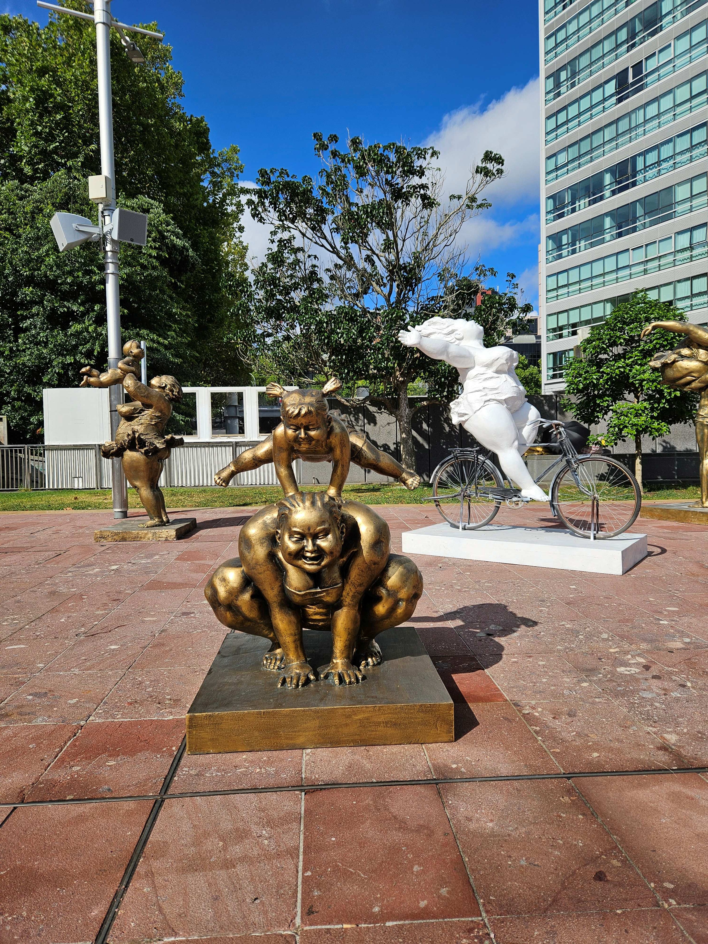 Bronze and white sculptures in a public space
